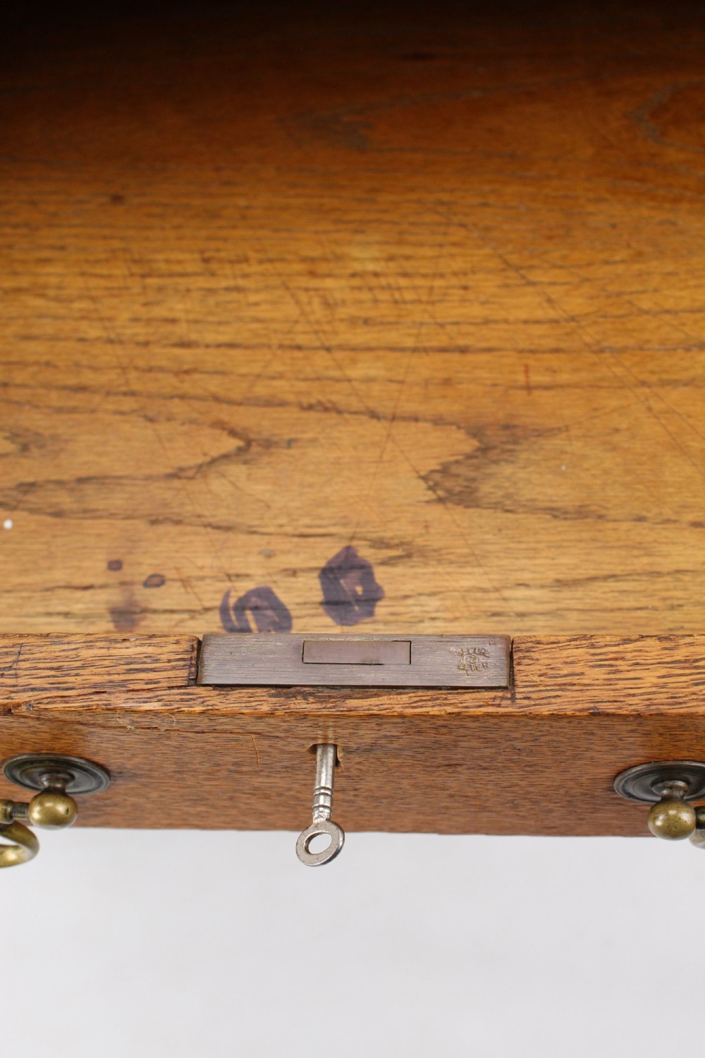 A late Victorian Arts and Crafts oak writing desk featuring drawers with brass swan-neck handles and tapered square legs. View VII