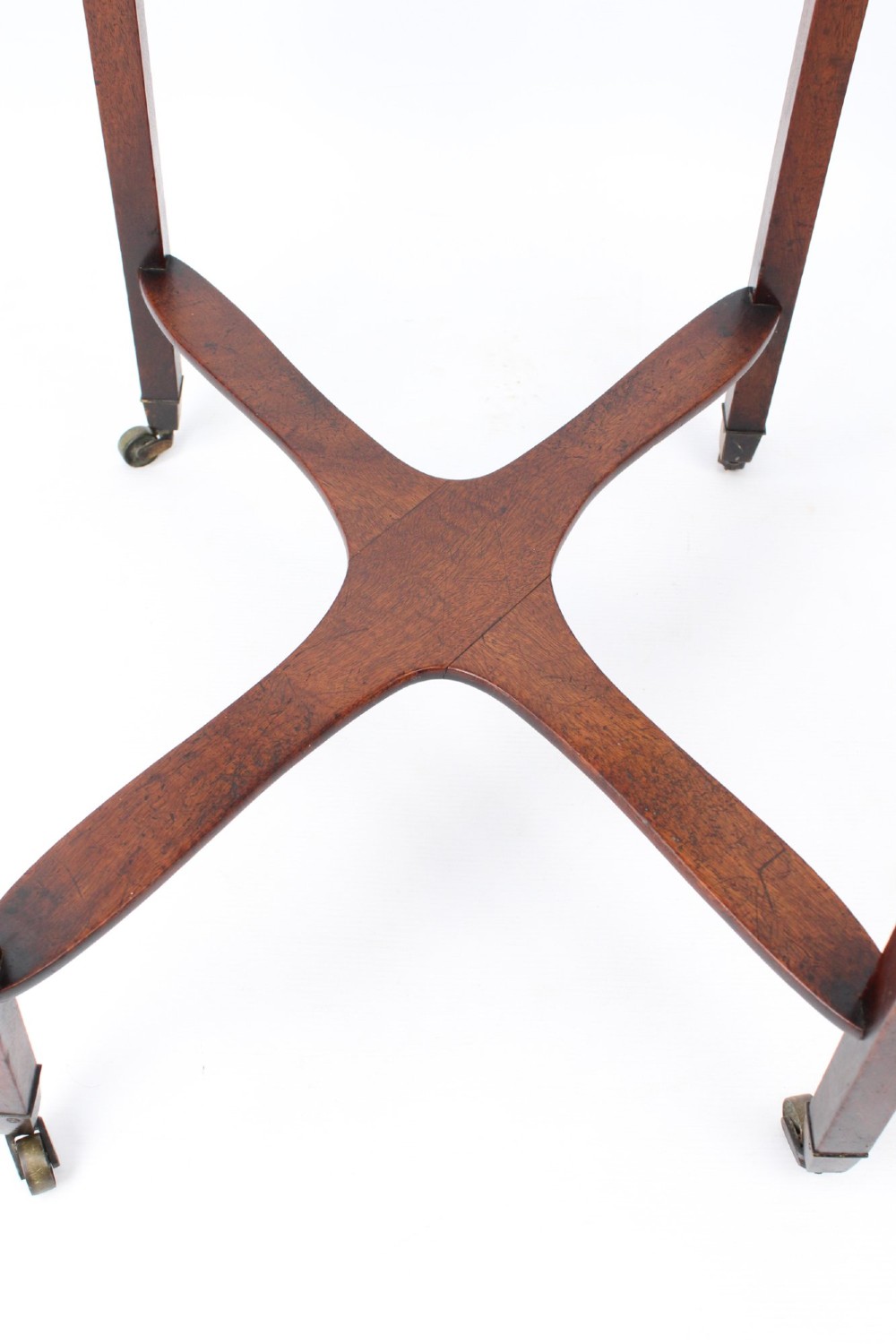 A small Georgian mahogany side table featuring a single drawer with brass ring handles, square tapered legs joined by an X-form stretcher, and brass castors. View XI