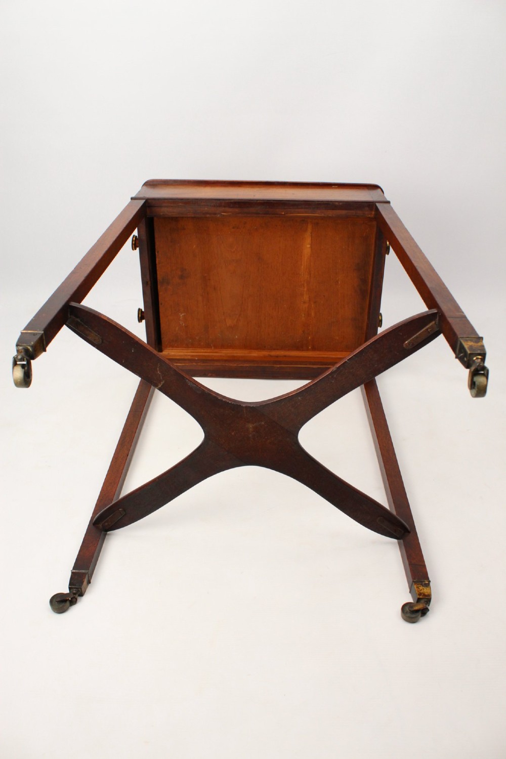 A small Georgian mahogany side table featuring a single drawer with brass ring handles, square tapered legs joined by an X-form stretcher, and brass castors. View XIII