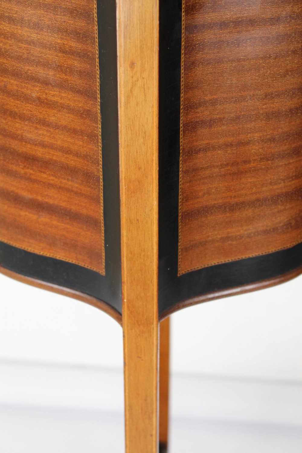 A tall Edwardian mahogany plant stand featuring shaped inlaid panels, four slender splayed legs, a lower shelf, and a dark metal liner. View XII