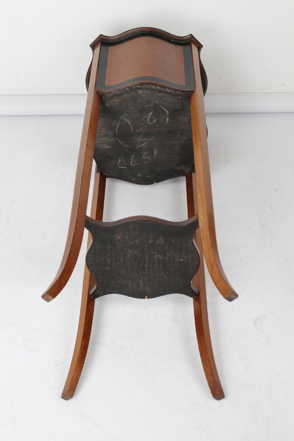 A tall Edwardian mahogany plant stand featuring shaped inlaid panels, four slender splayed legs, a lower shelf, and a dark metal liner. View XIII