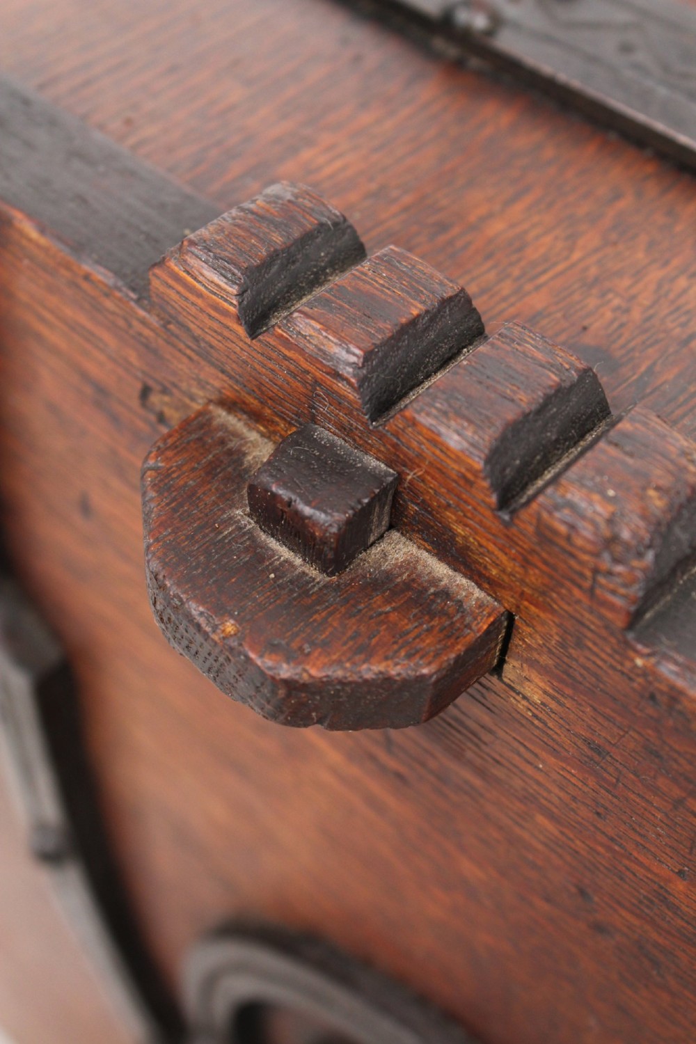A Victorian Gothic Revival dark oak coal scuttle featuring sloped timber lids, a turned handle, and black wrought iron scrollwork straps. View IX