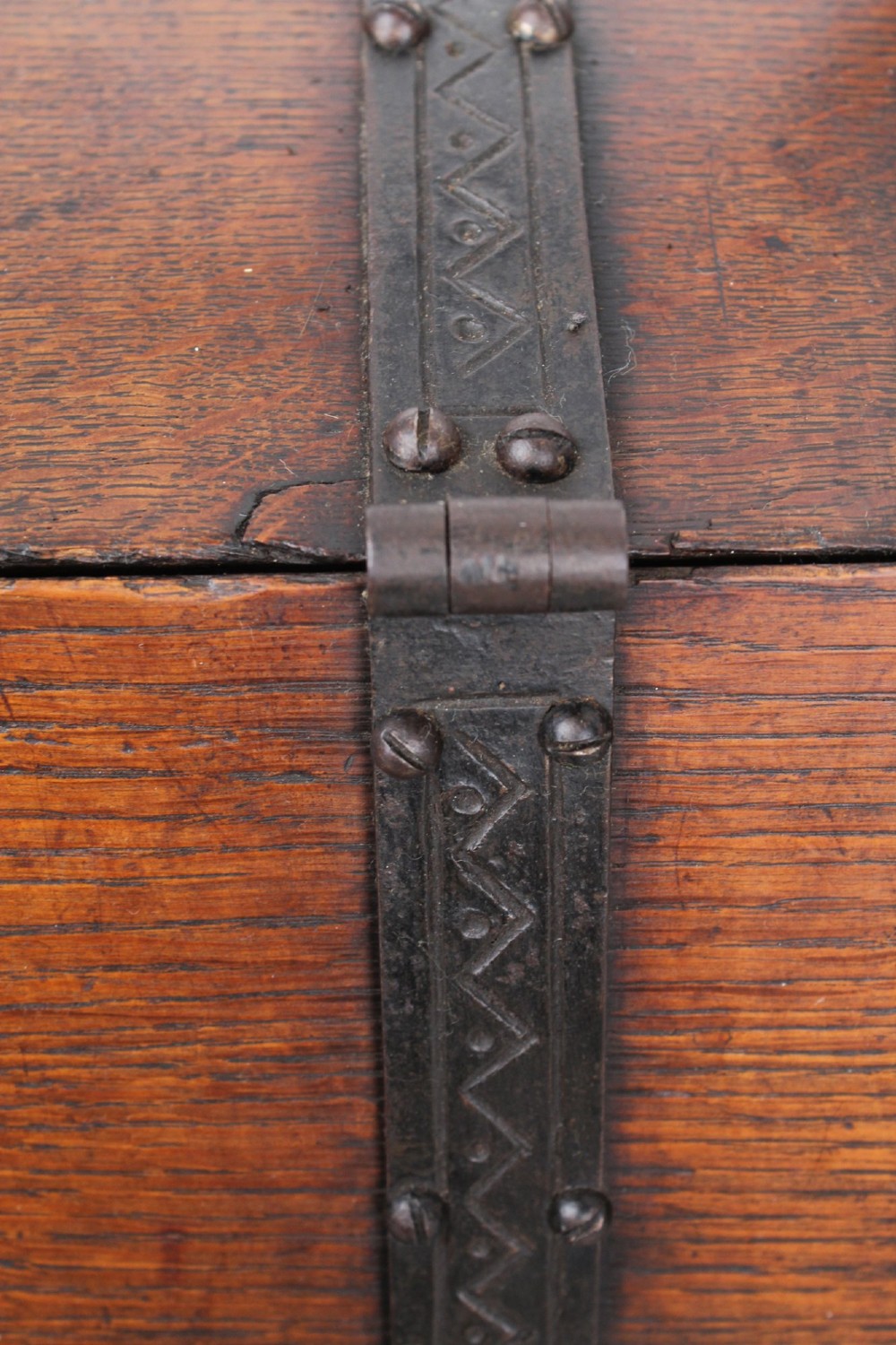 A Victorian Gothic Revival dark oak coal scuttle featuring sloped timber lids, a turned handle, and black wrought iron scrollwork straps. View XI