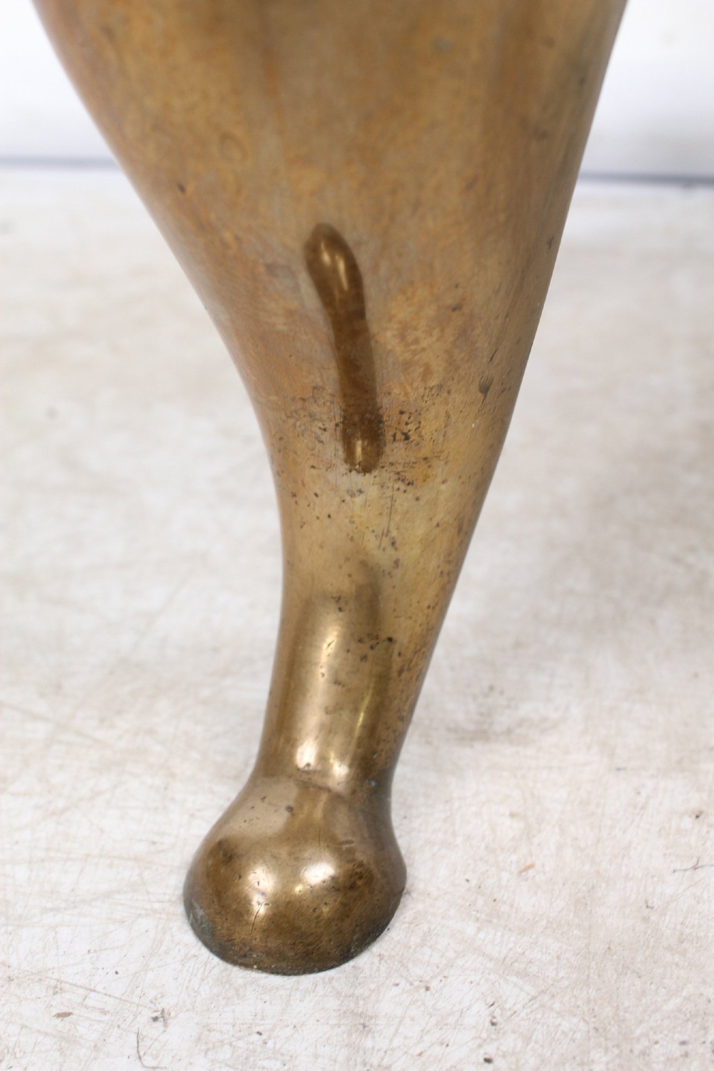 An antique Georgian brass footman featuring cabriole front legs, turned rear legs, side drop handles, and a rectangular top surface. View XIII