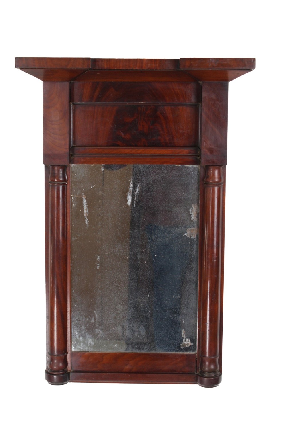 A small rectangular Regency mahogany pier mirror featuring an overhanging upper cornice, side column supports, and foxed glass.