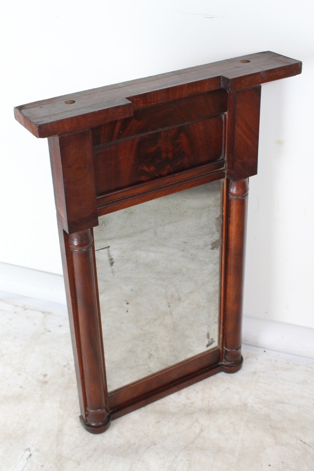 A small rectangular Regency mahogany pier mirror featuring an overhanging upper cornice, side column supports, and foxed glass. View III