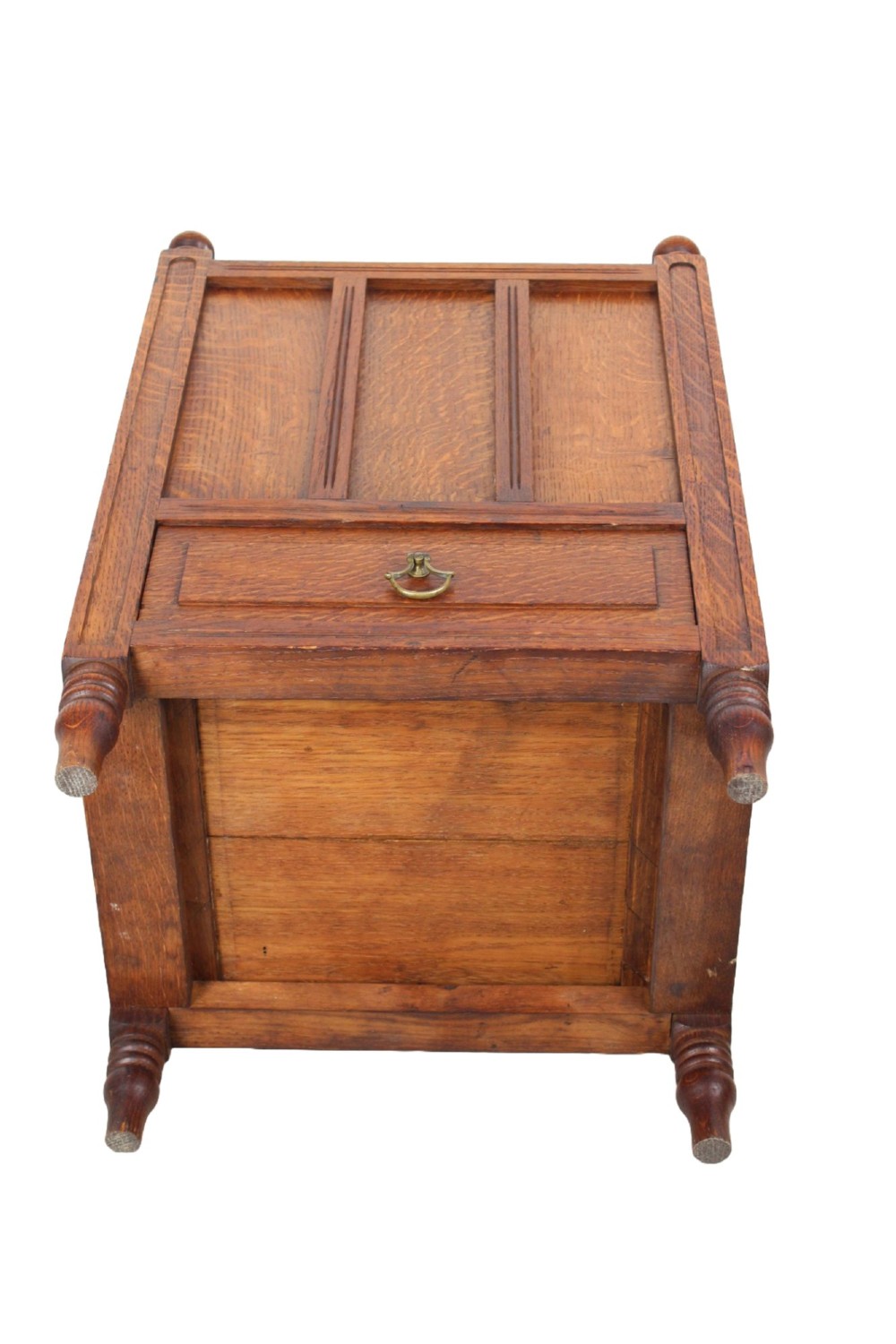 An Edwardian oak Canterbury with vertical panelled sides, internal dividers, a lower drawer with a brass handle, and corner finials. View XIII