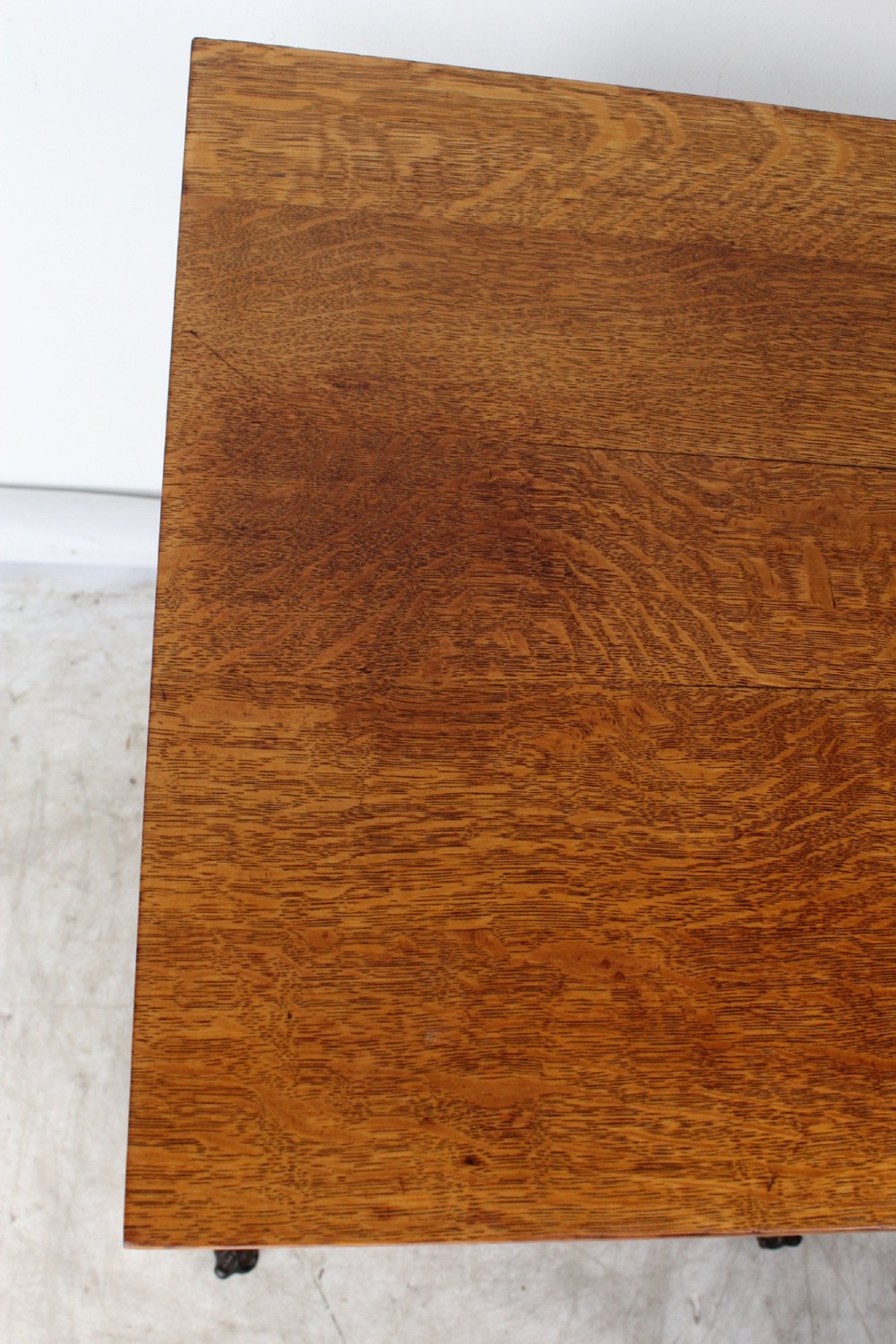An antique warm brown oak side table featuring bobbin-turned legs, a lower rectangular shelf, and claw feet. View V