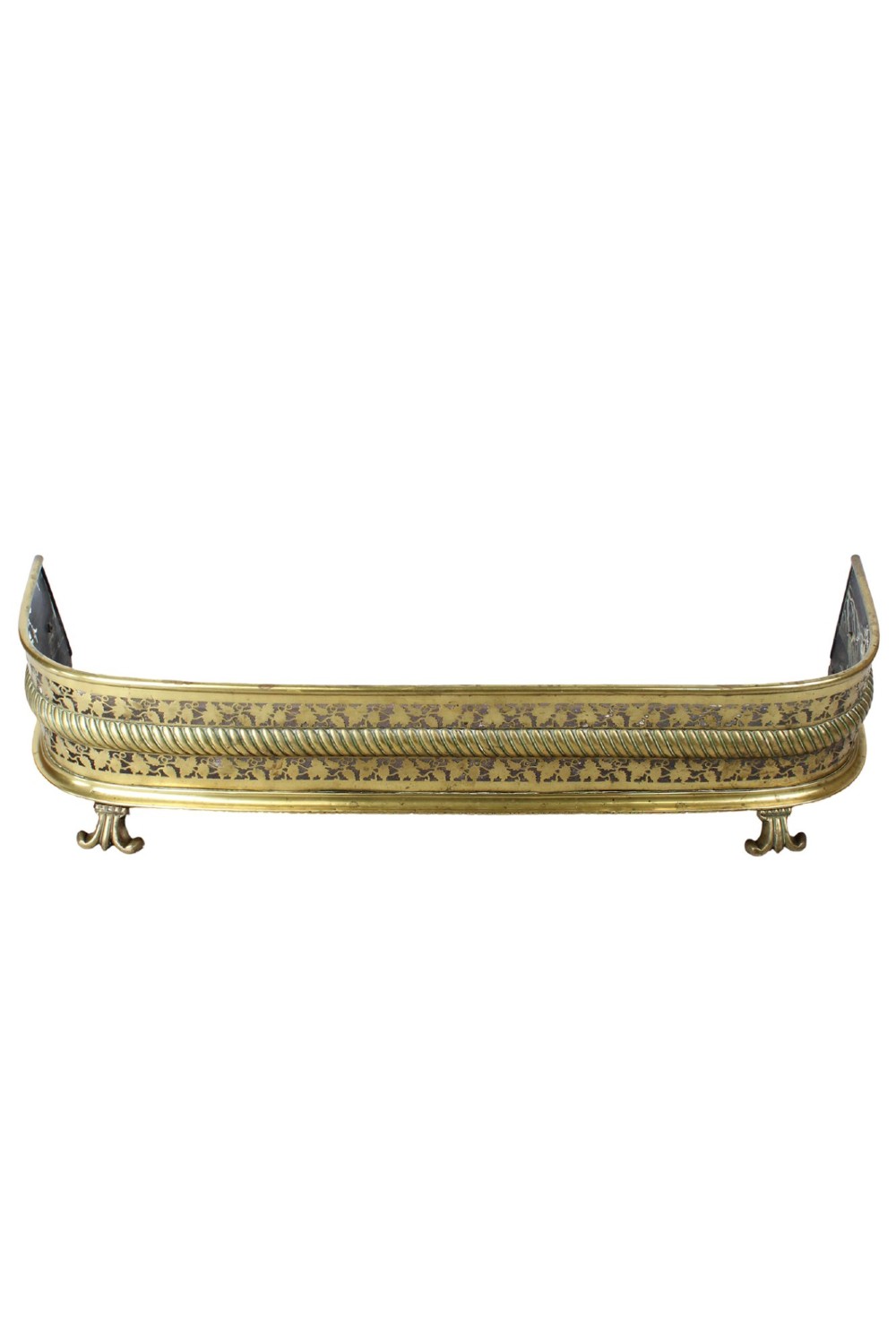 A low curved Victorian brass fire fender displaying a pierced fretwork panel, a central gadrooned band, and short cast scroll feet. View II