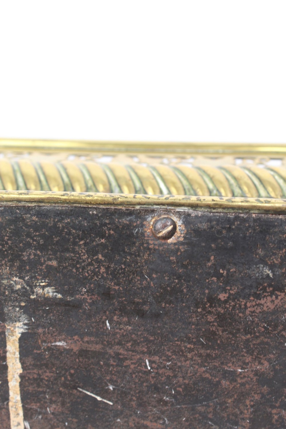 A low curved Victorian brass fire fender displaying a pierced fretwork panel, a central gadrooned band, and short cast scroll feet. View XIII