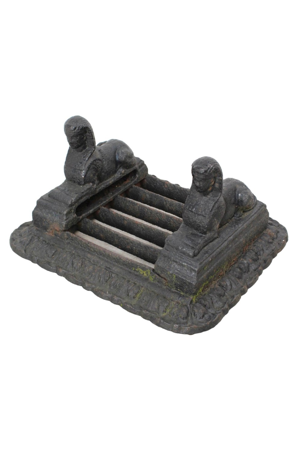 A dark cast iron boot scraper featuring twin sphinx figures flanking a central slatted grate set upon a decorative moulded base. View II