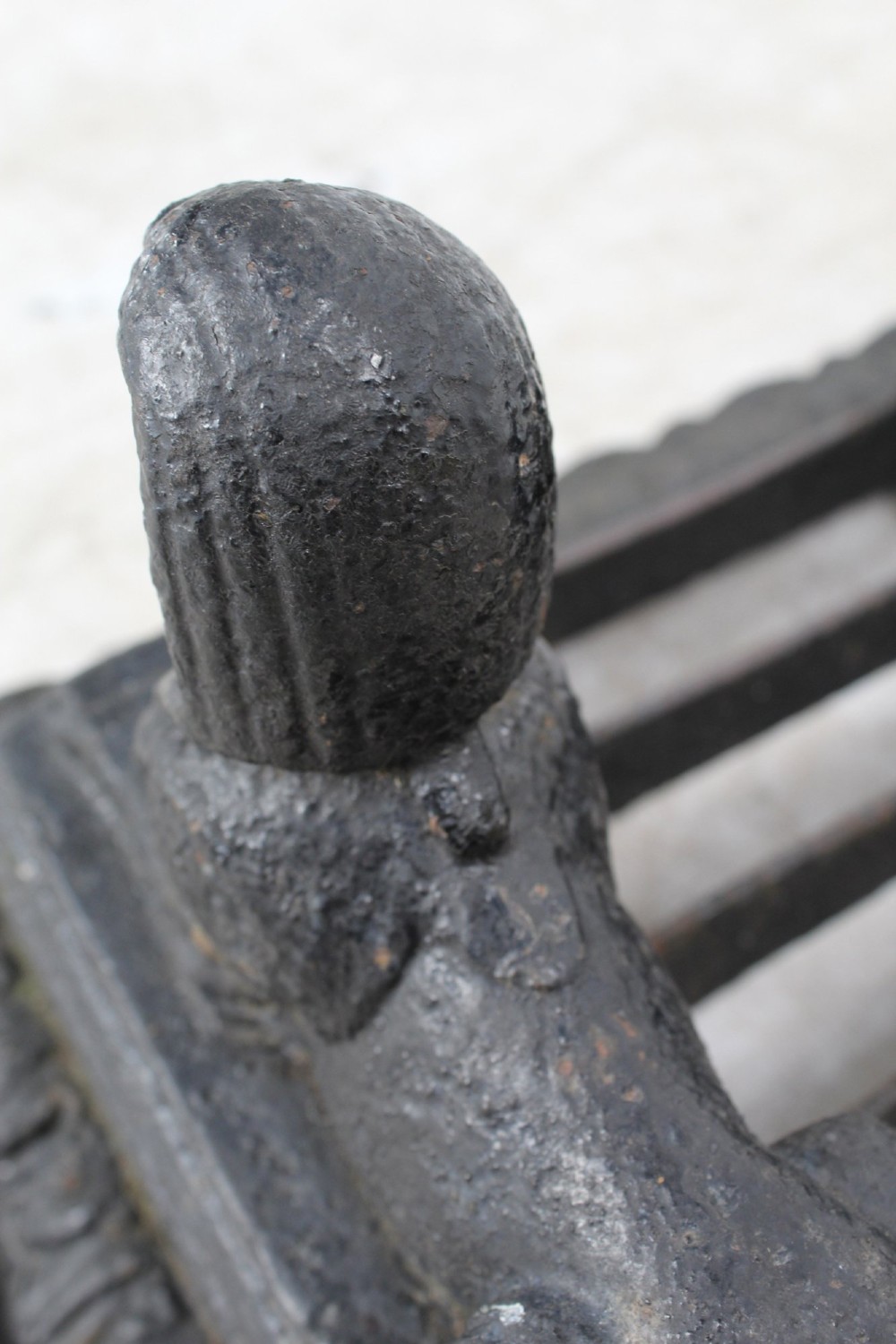 A dark cast iron boot scraper featuring twin sphinx figures flanking a central slatted grate set upon a decorative moulded base. View XIII