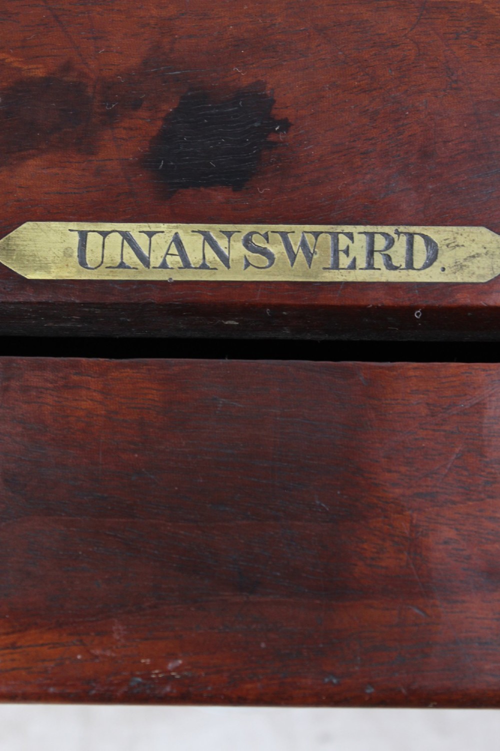 A Victorian mahogany letter box featuring two top slots labeled Answerd and Unanswerd with brass plaques and a circular keyhole escutcheon on the front. View VIII