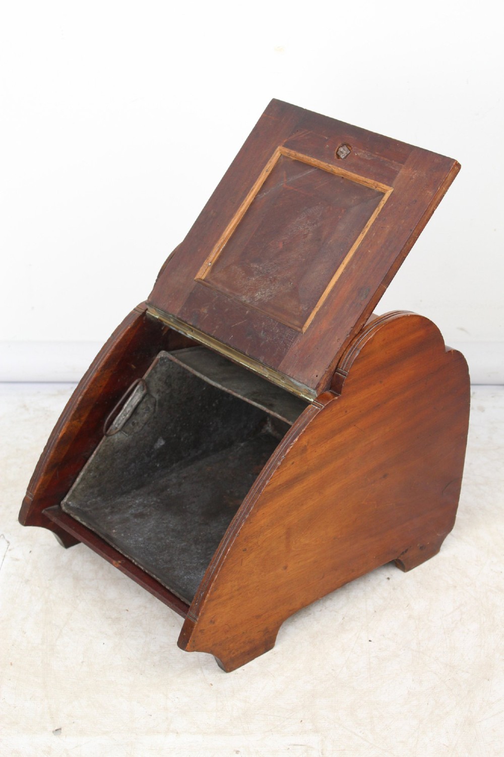 A Victorian mahogany coal scuttle featuring a slanted drop-front door with decorative timber inlay and a polished brass carrying handle on top. View II