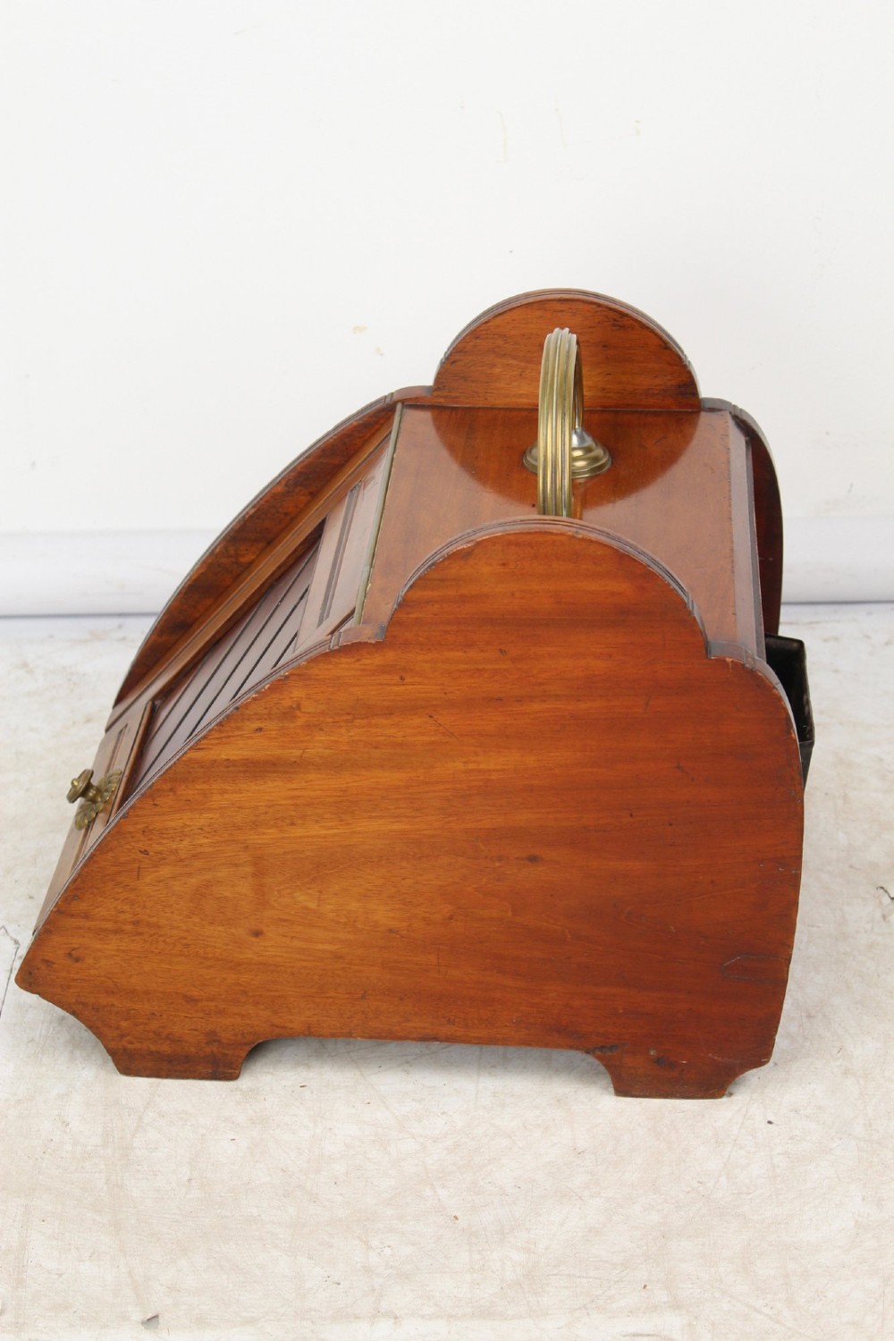 A Victorian mahogany coal scuttle featuring a slanted drop-front door with decorative timber inlay and a polished brass carrying handle on top. View V