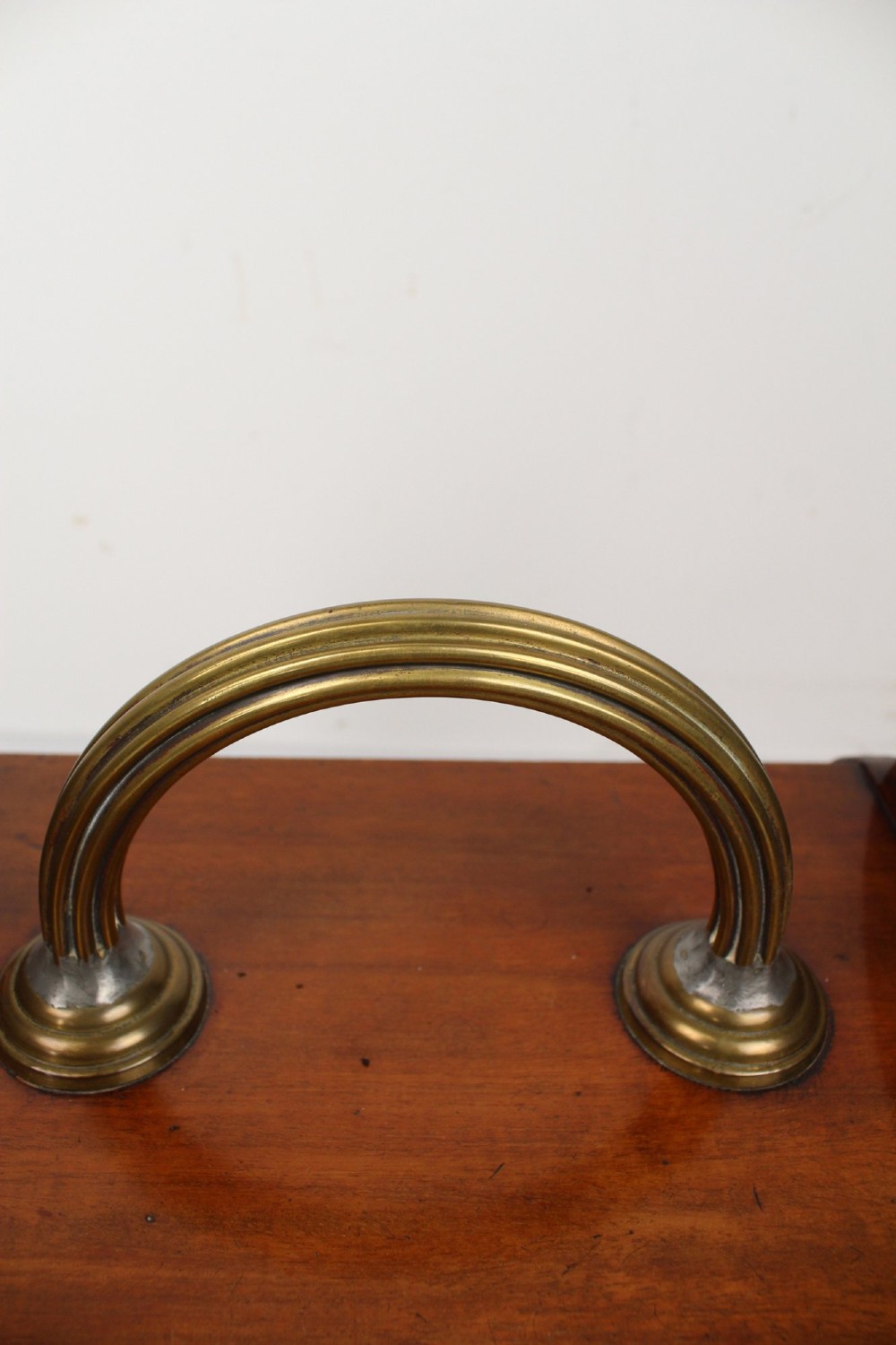 A Victorian mahogany coal scuttle featuring a slanted drop-front door with decorative timber inlay and a polished brass carrying handle on top. View VIII