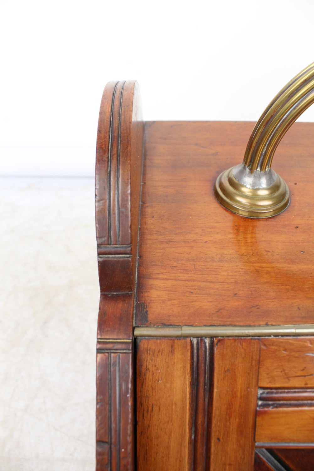 A Victorian mahogany coal scuttle featuring a slanted drop-front door with decorative timber inlay and a polished brass carrying handle on top. View XI
