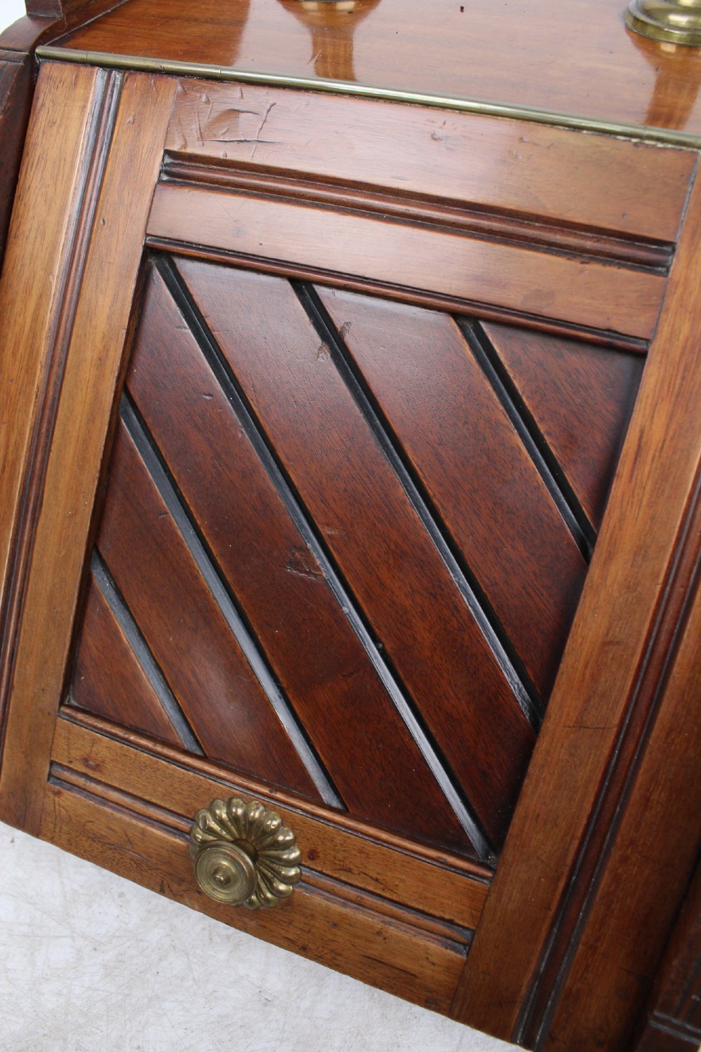 A Victorian mahogany coal scuttle featuring a slanted drop-front door with decorative timber inlay and a polished brass carrying handle on top. View XII