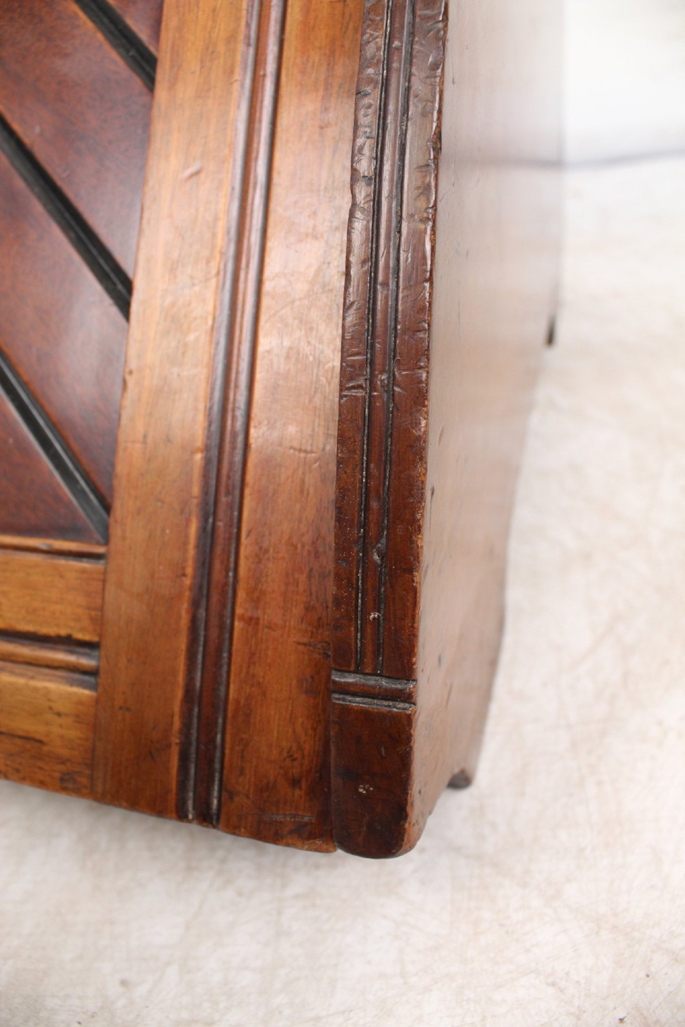 A Victorian mahogany coal scuttle featuring a slanted drop-front door with decorative timber inlay and a polished brass carrying handle on top. View XIII