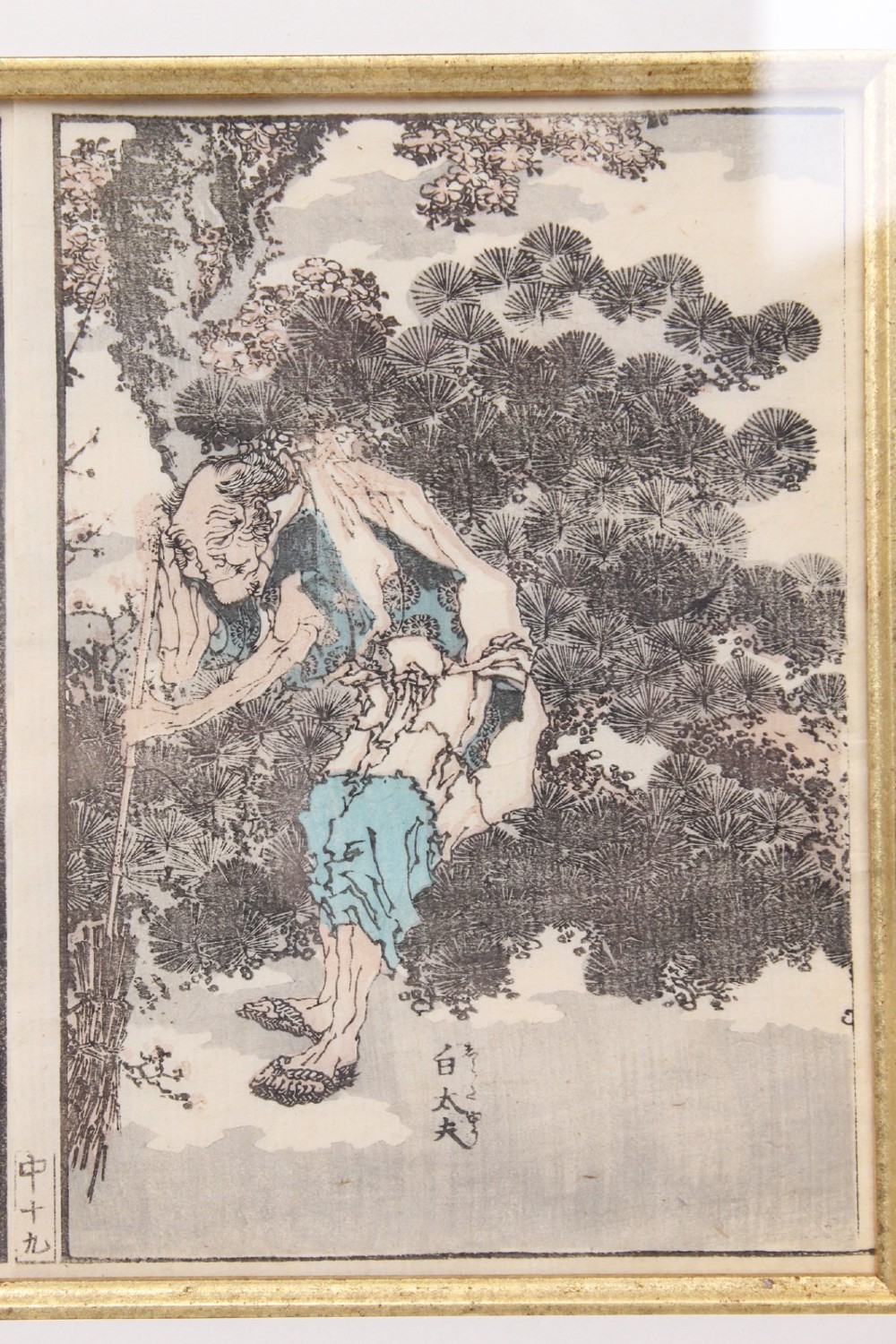 A pair of framed Japanese woodblock prints featuring detailed figurative and landscape illustrations mounted in cream mats within dark wooden frames. View VII