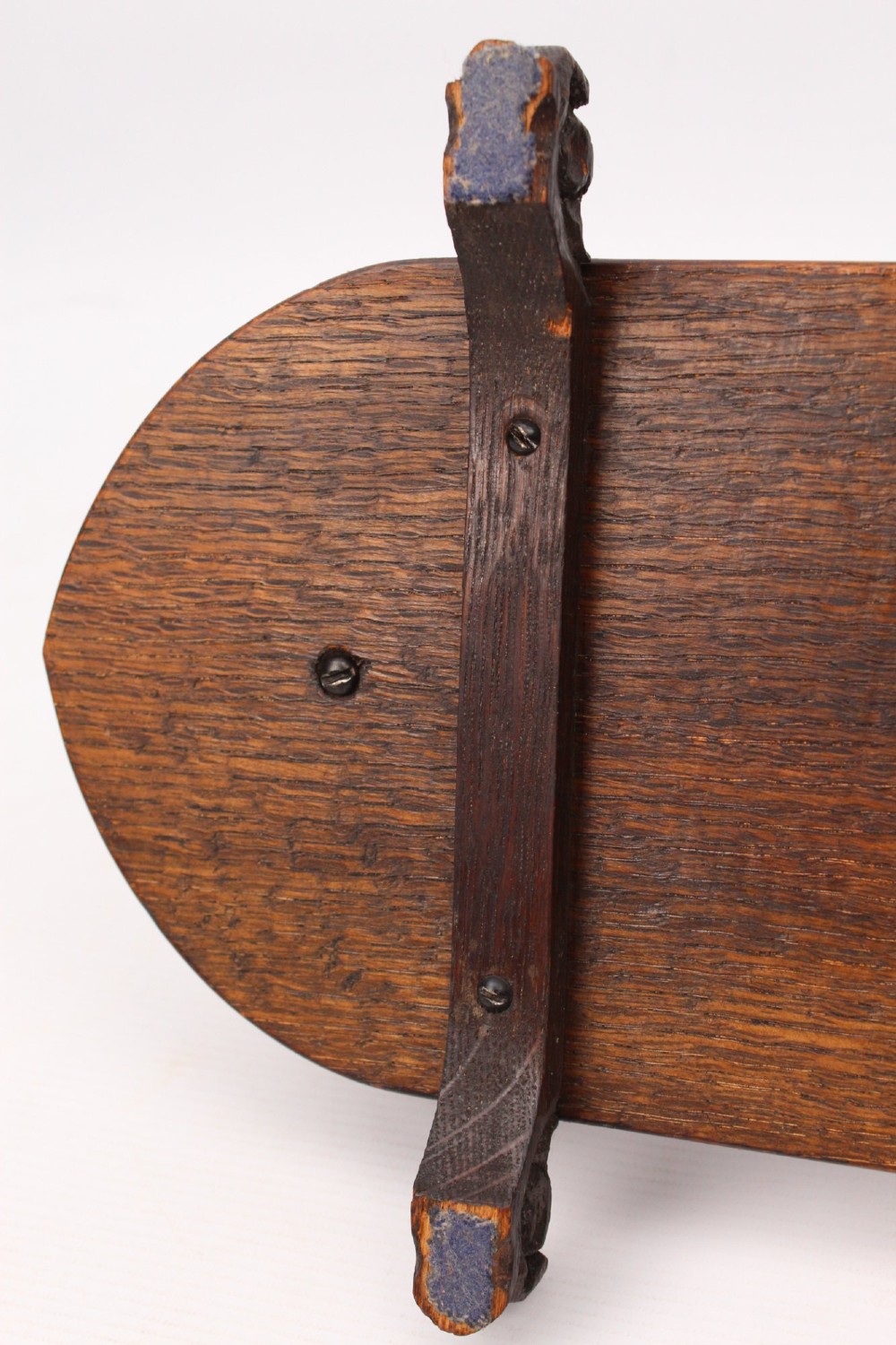 A dark oak desktop book stand featuring pointed arch uprights, carved mythical creature side accents, and scroll feet. View VIII