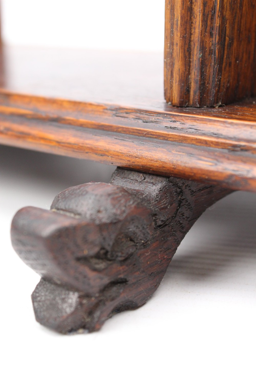 A dark oak desktop book stand featuring pointed arch uprights, carved mythical creature side accents, and scroll feet. View XI