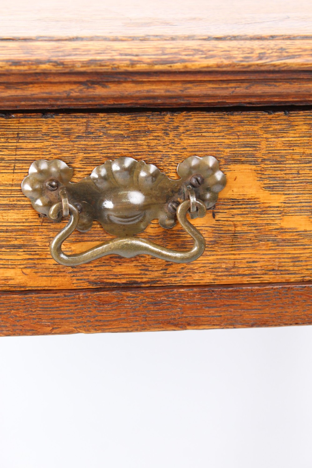 A compact Arts and Crafts oak writing desk featuring a single drawer with a brass drop handle, straight square legs, and lower stretchers. View XII