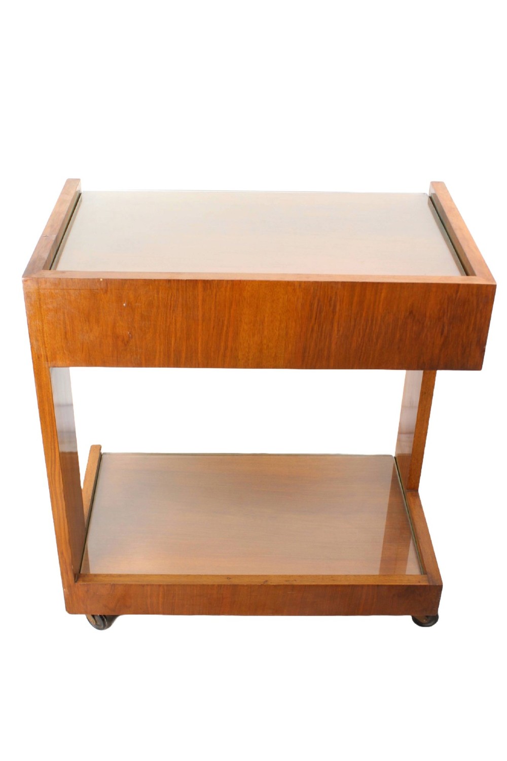 An Art Deco warm brown walnut two-tier trolley featuring inset glass tops, a drawer with a brass keyhole, and concealed castors. View VI