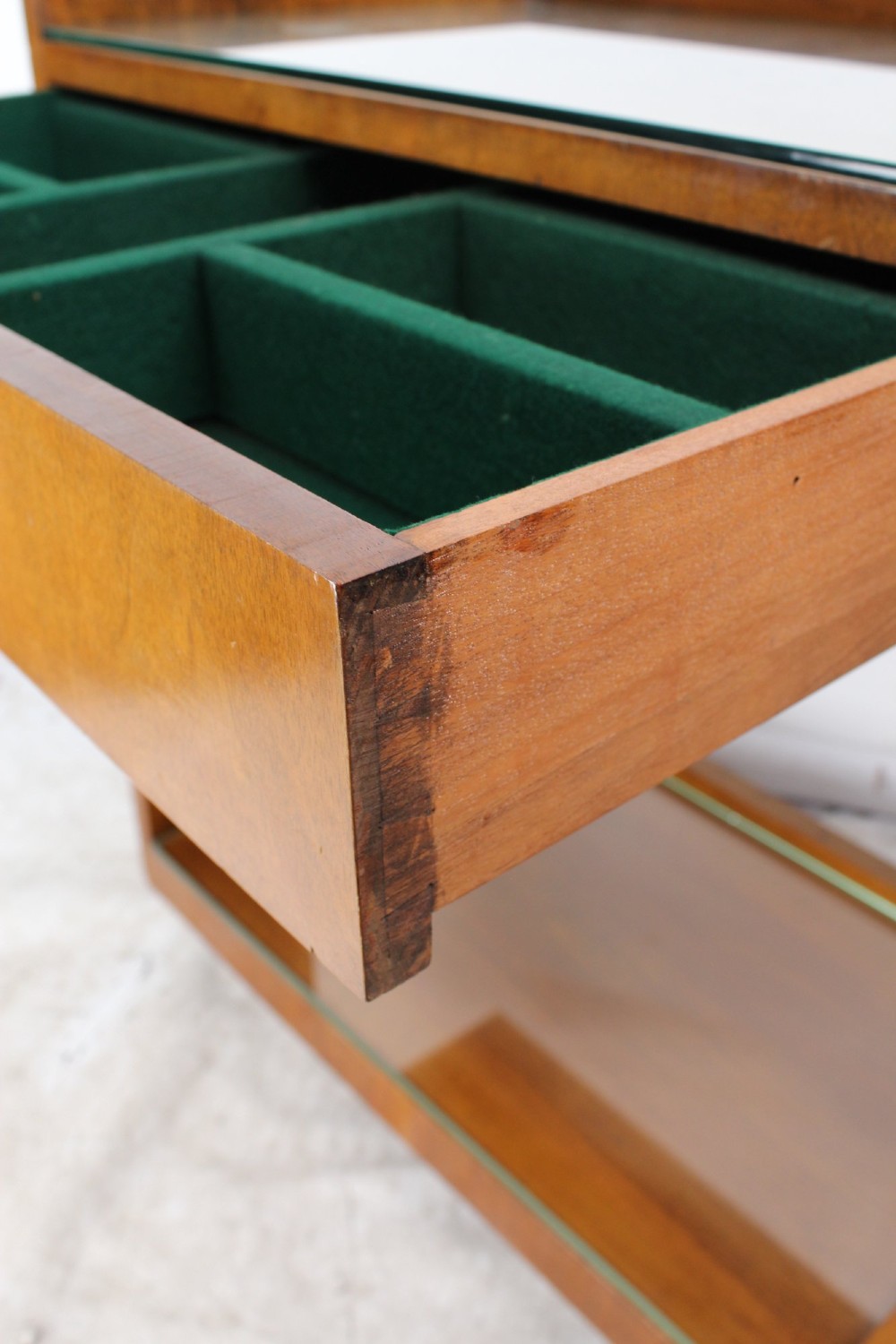 An Art Deco warm brown walnut two-tier trolley featuring inset glass tops, a drawer with a brass keyhole, and concealed castors. View VII