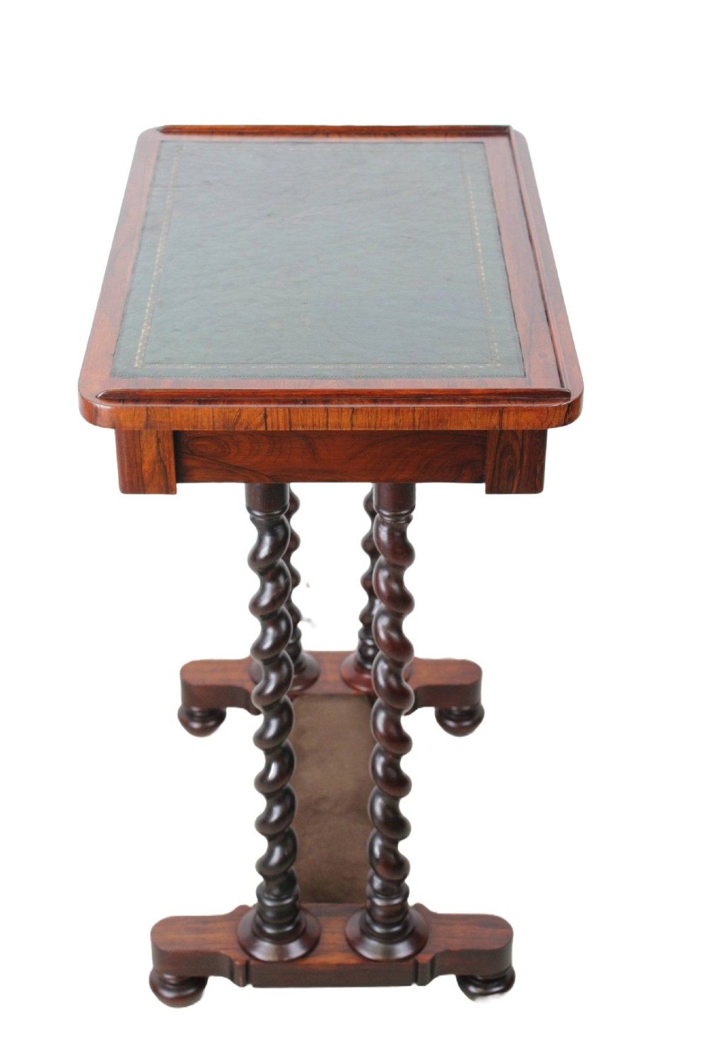 A small Regency rosewood side table featuring an inset green leather top with gold leaf tooling, supported by twin barley twist columns on a trestle base. View V