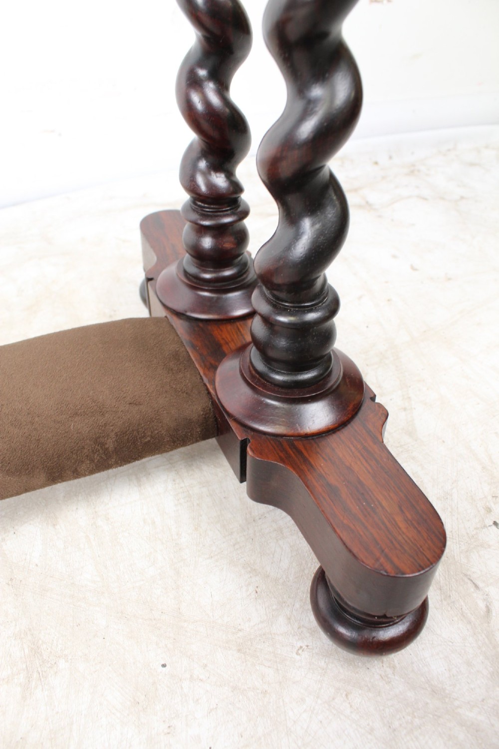 A small Regency rosewood side table featuring an inset green leather top with gold leaf tooling, supported by twin barley twist columns on a trestle base. View IX