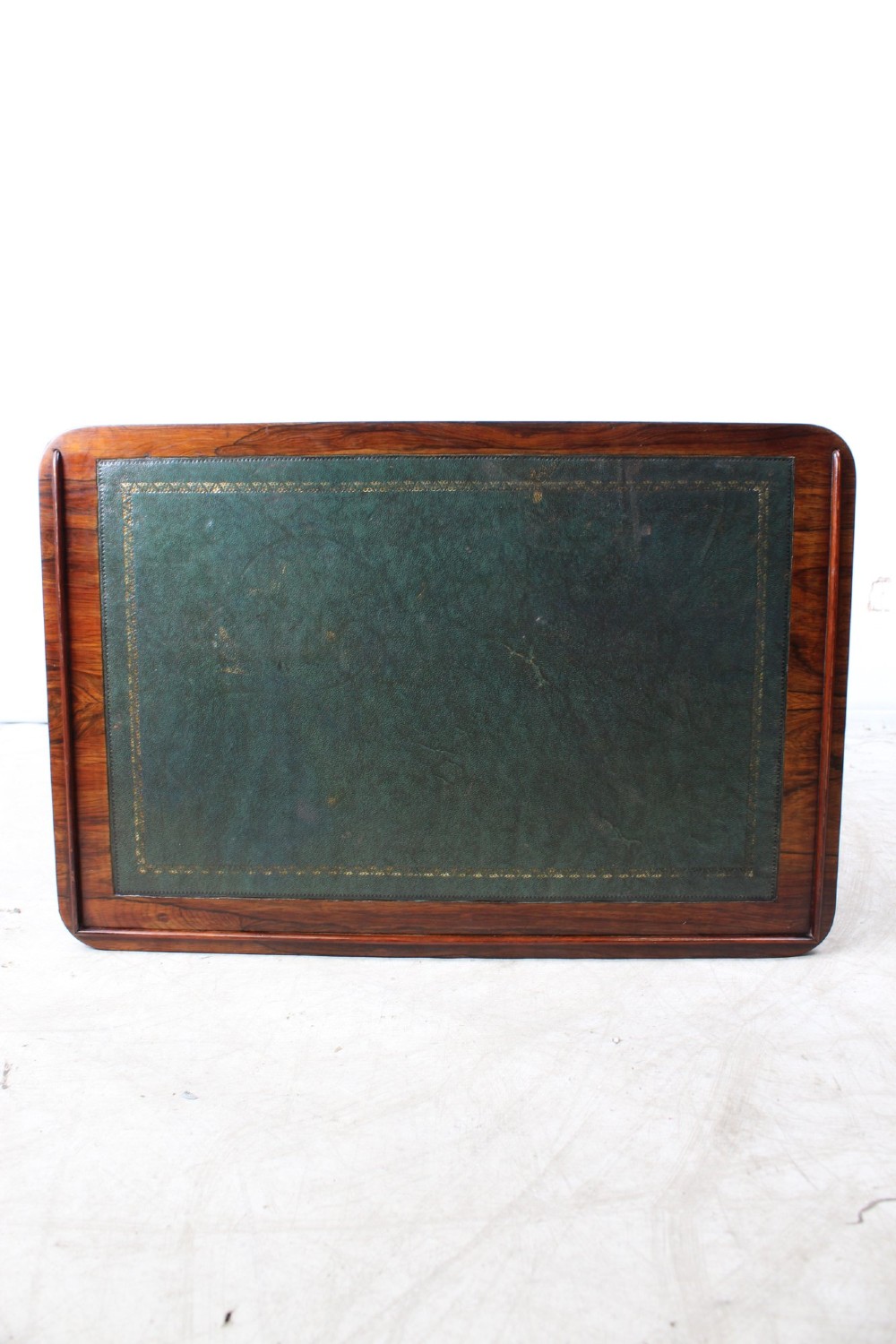 A small Regency rosewood side table featuring an inset green leather top with gold leaf tooling, supported by twin barley twist columns on a trestle base. View XIII