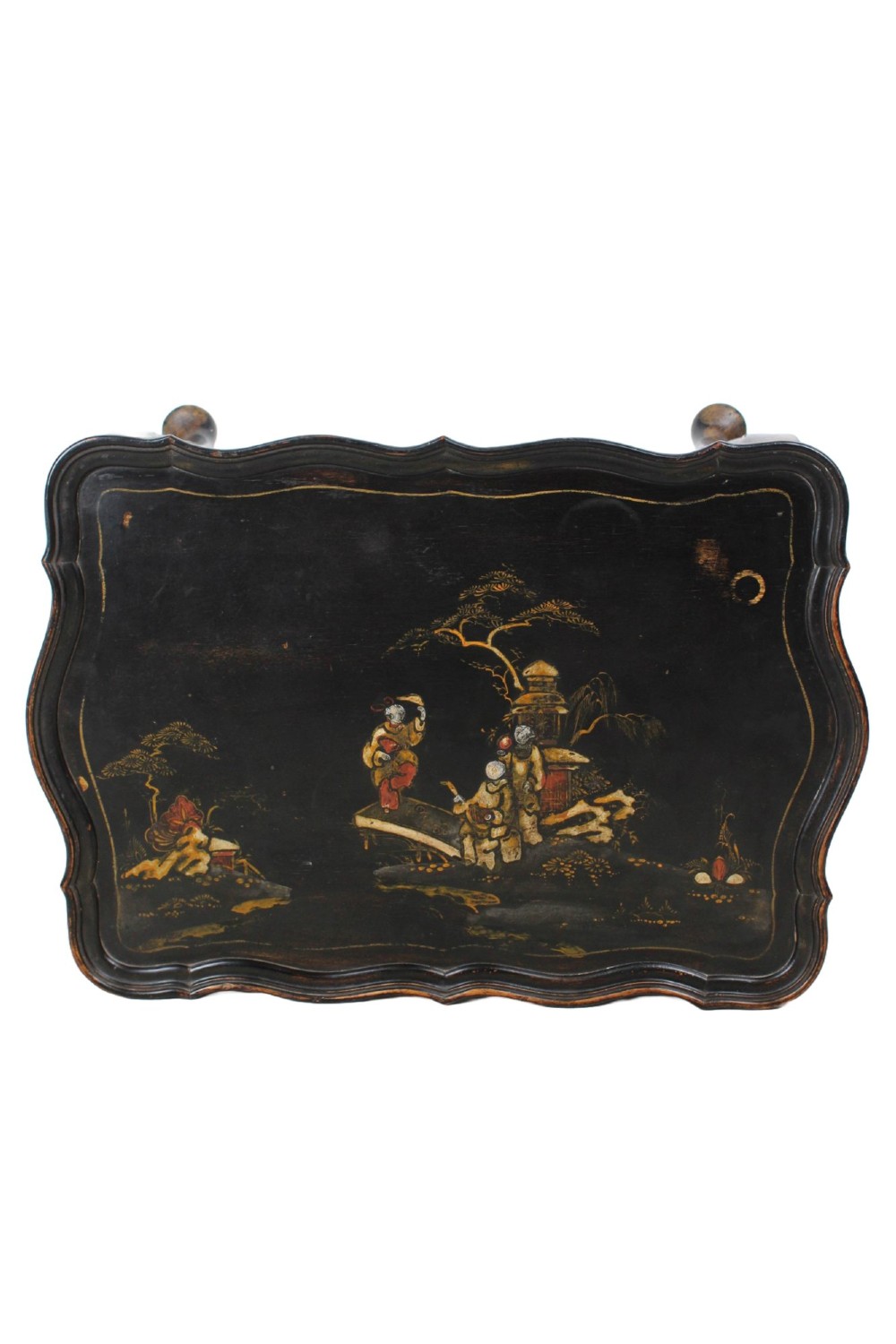 A low black lacquered Edwardian coffee table featuring gilded Chinoiserie figures, a serpentine tray-top edge, and cabriole legs. View VII