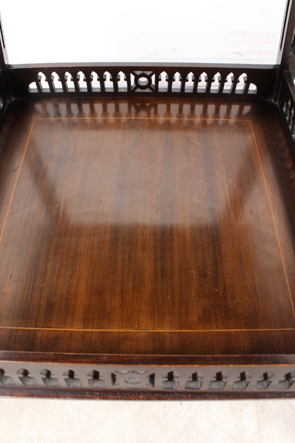 An Edwardian mahogany square side table featuring a central inlaid sunburst medallion, crossbanded border, and a lower undertier shelf with a pierced gallery. View IX