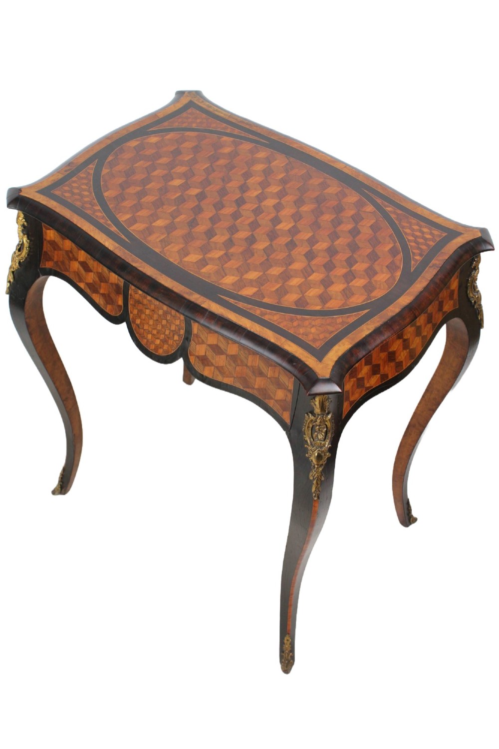 A Victorian Louis XV Revival writing table featuring geometric cube parquetry inlay, serpentine edges, ebonised borders, cabriole legs, and gold-toned bronze mounts. View II