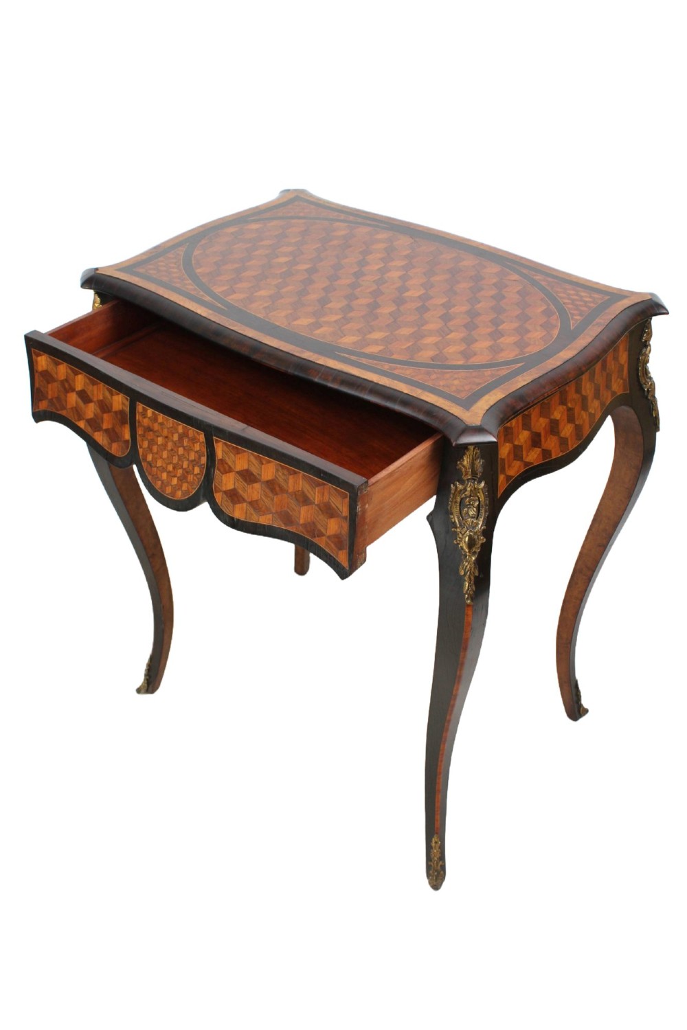 A Victorian Louis XV Revival writing table featuring geometric cube parquetry inlay, serpentine edges, ebonised borders, cabriole legs, and gold-toned bronze mounts. View III