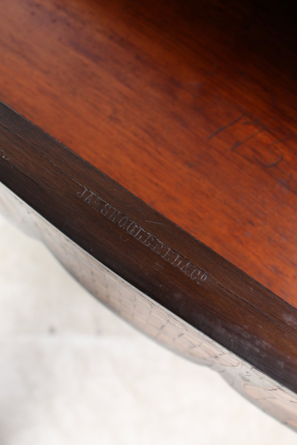 A Victorian Louis XV Revival writing table featuring geometric cube parquetry inlay, serpentine edges, ebonised borders, cabriole legs, and gold-toned bronze mounts. View VII