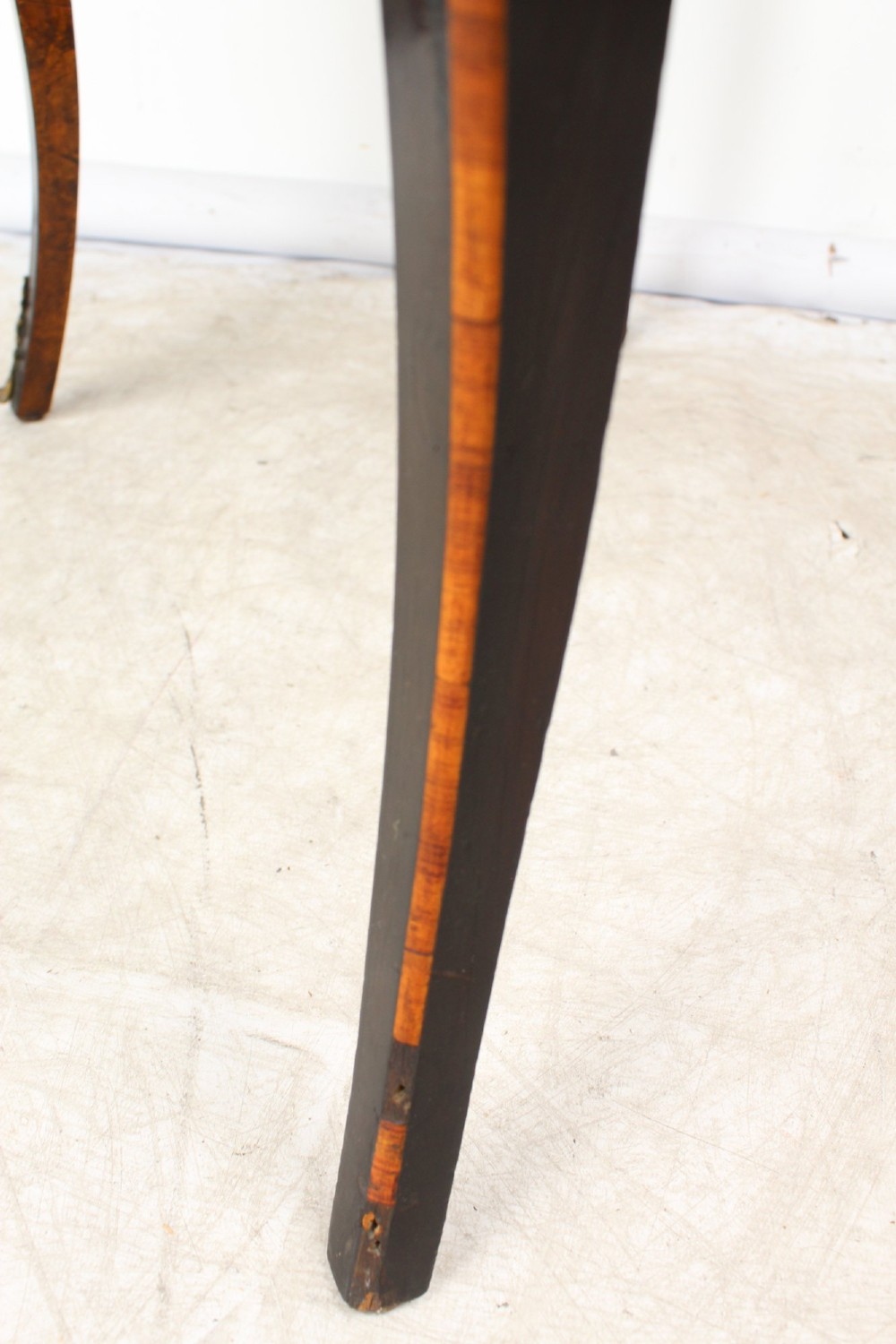 A Victorian Louis XV Revival writing table featuring geometric cube parquetry inlay, serpentine edges, ebonised borders, cabriole legs, and gold-toned bronze mounts. View XIV