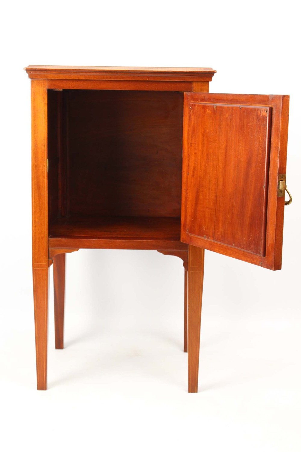 An Edwardian mahogany bedside cabinet featuring satinwood stringing inlay, a single panelled door with a brass handle, and square tapered legs. View II
