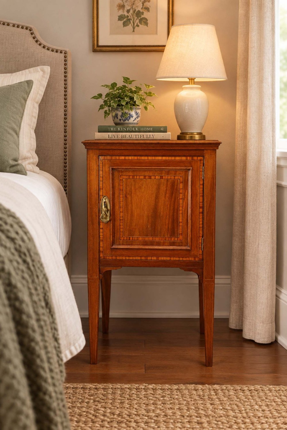 An Edwardian mahogany bedside cabinet featuring satinwood stringing inlay, a single panelled door with a brass handle, and square tapered legs. View XIII