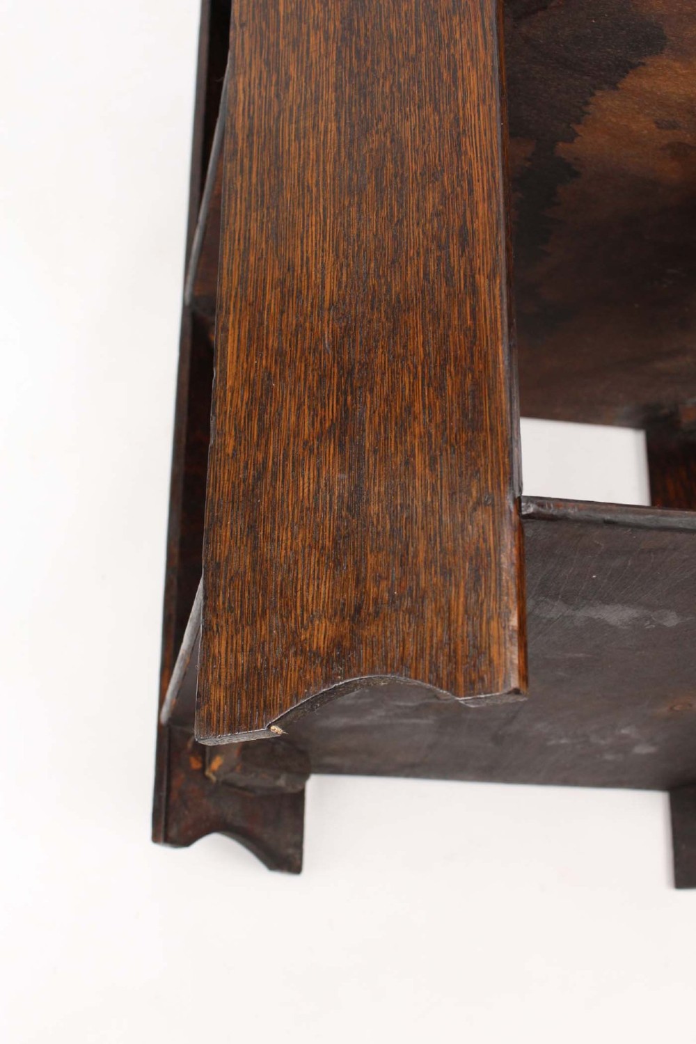 An octagonal dark oak Art Deco style book table featuring three vertical side panels and two open lower shelves. View VI