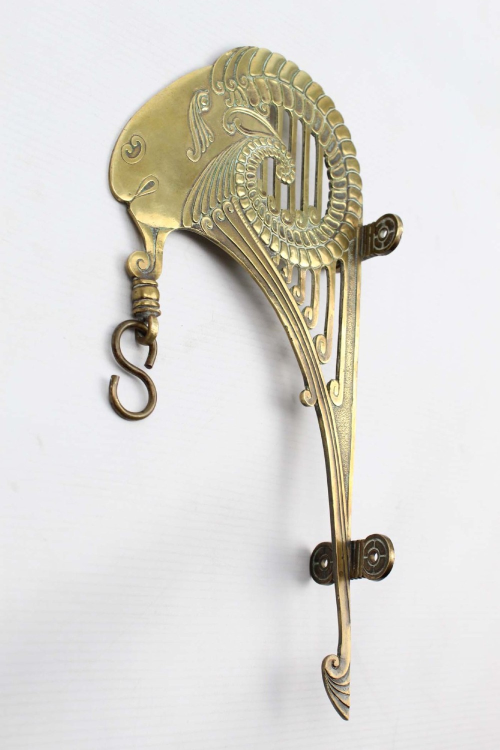 A stylized cast brass Art Deco wall hanging bracket featuring openwork scroll details and a lower swivel hook. View II