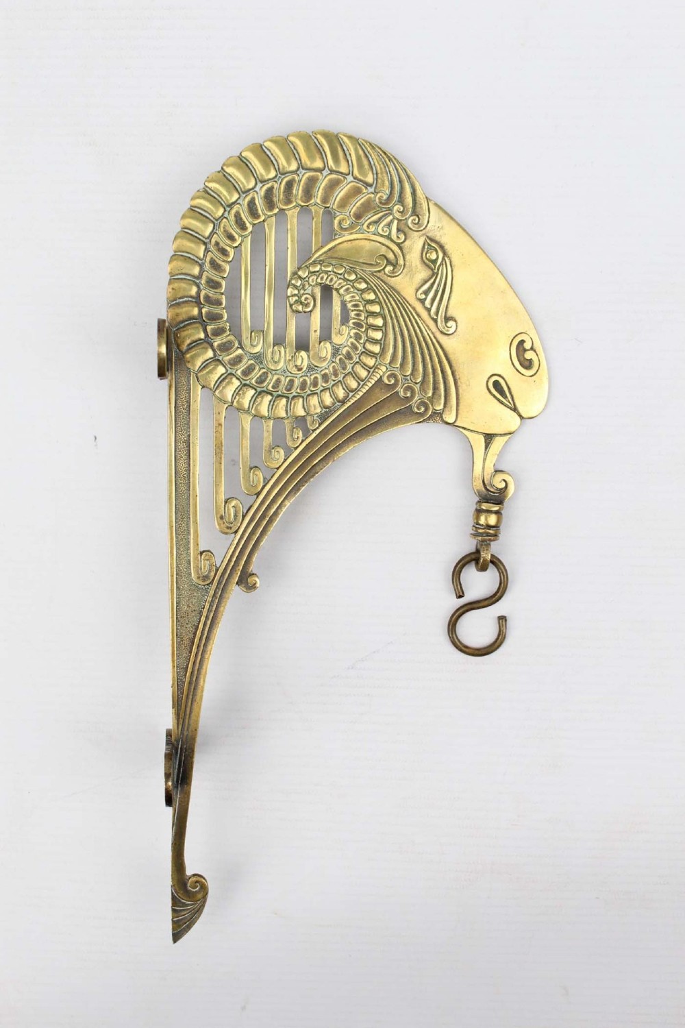 A stylized cast brass Art Deco wall hanging bracket featuring openwork scroll details and a lower swivel hook. View III