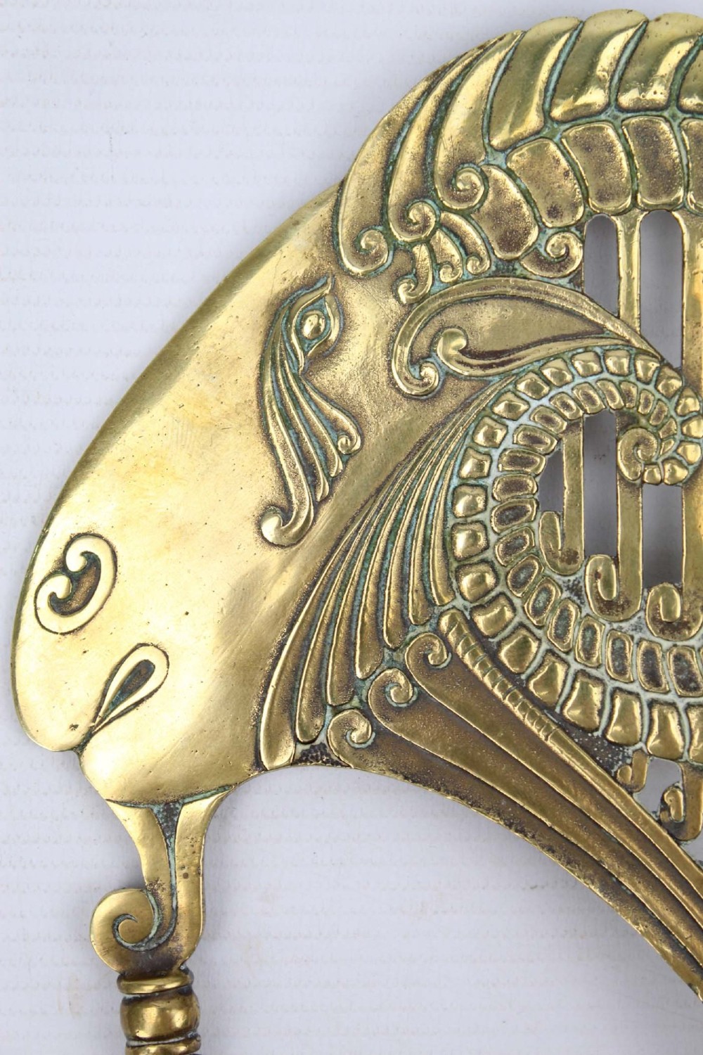 A stylized cast brass Art Deco wall hanging bracket featuring openwork scroll details and a lower swivel hook. View V