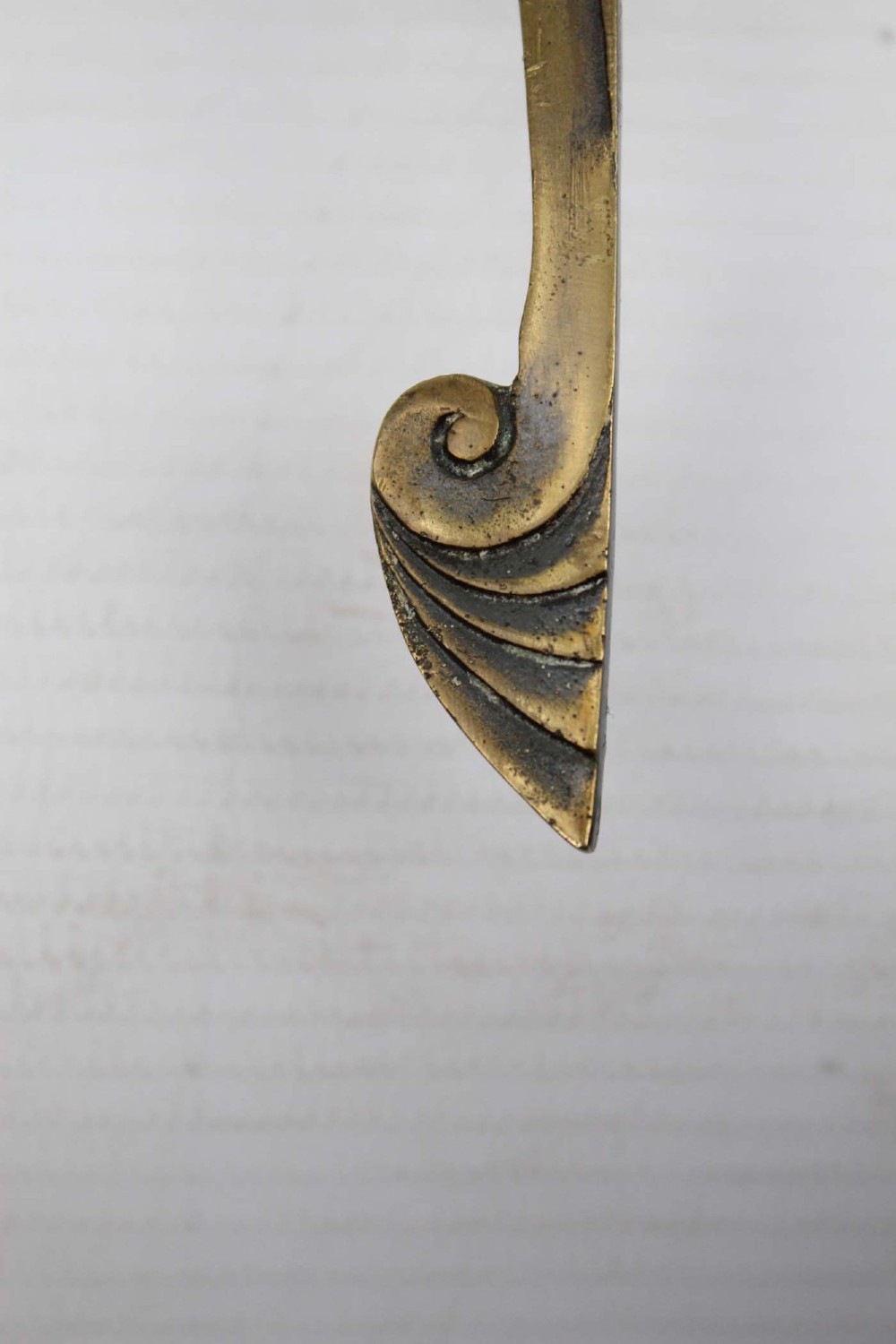 A stylized cast brass Art Deco wall hanging bracket featuring openwork scroll details and a lower swivel hook. View VIII
