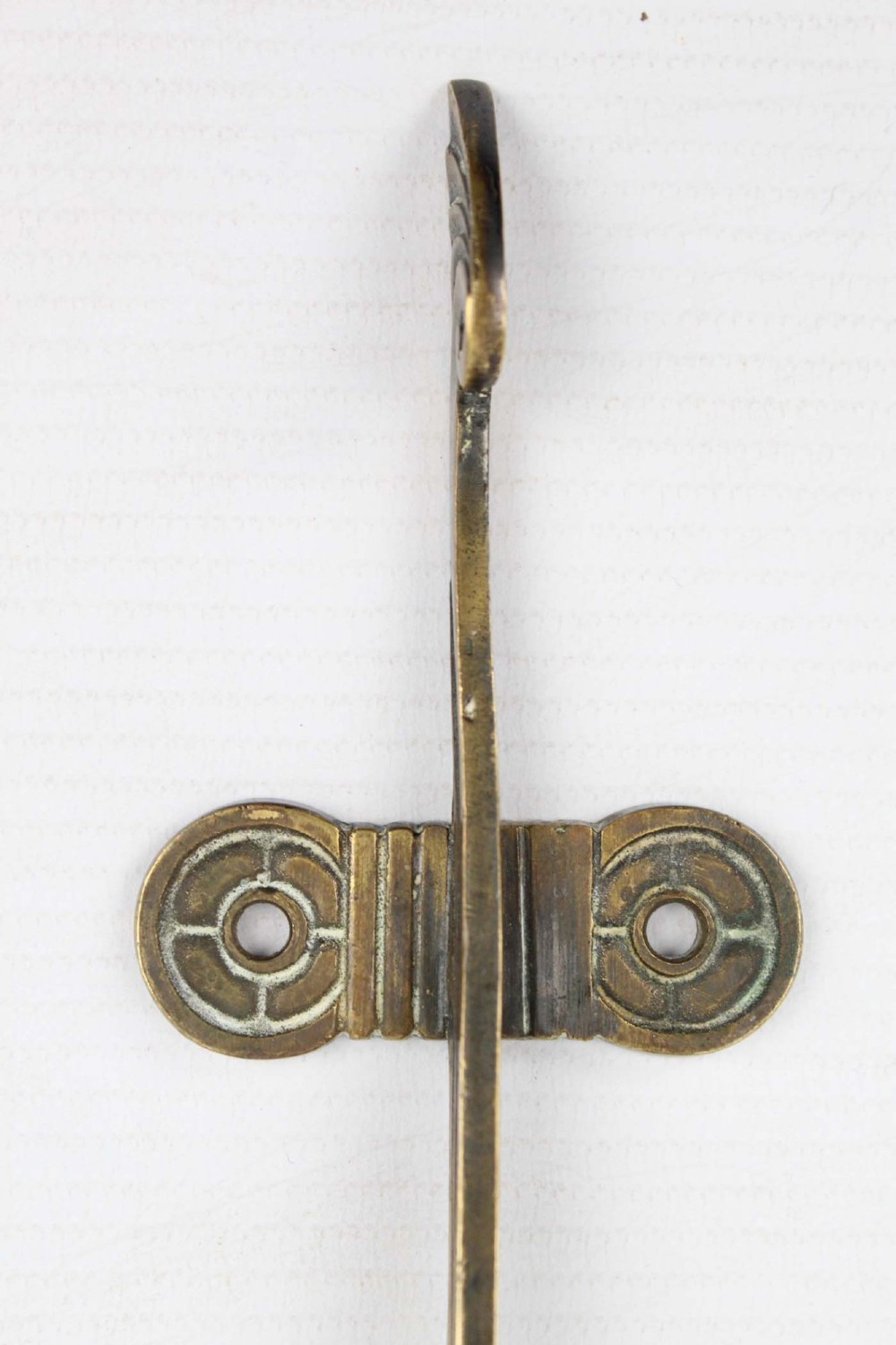A stylized cast brass Art Deco wall hanging bracket featuring openwork scroll details and a lower swivel hook. View X