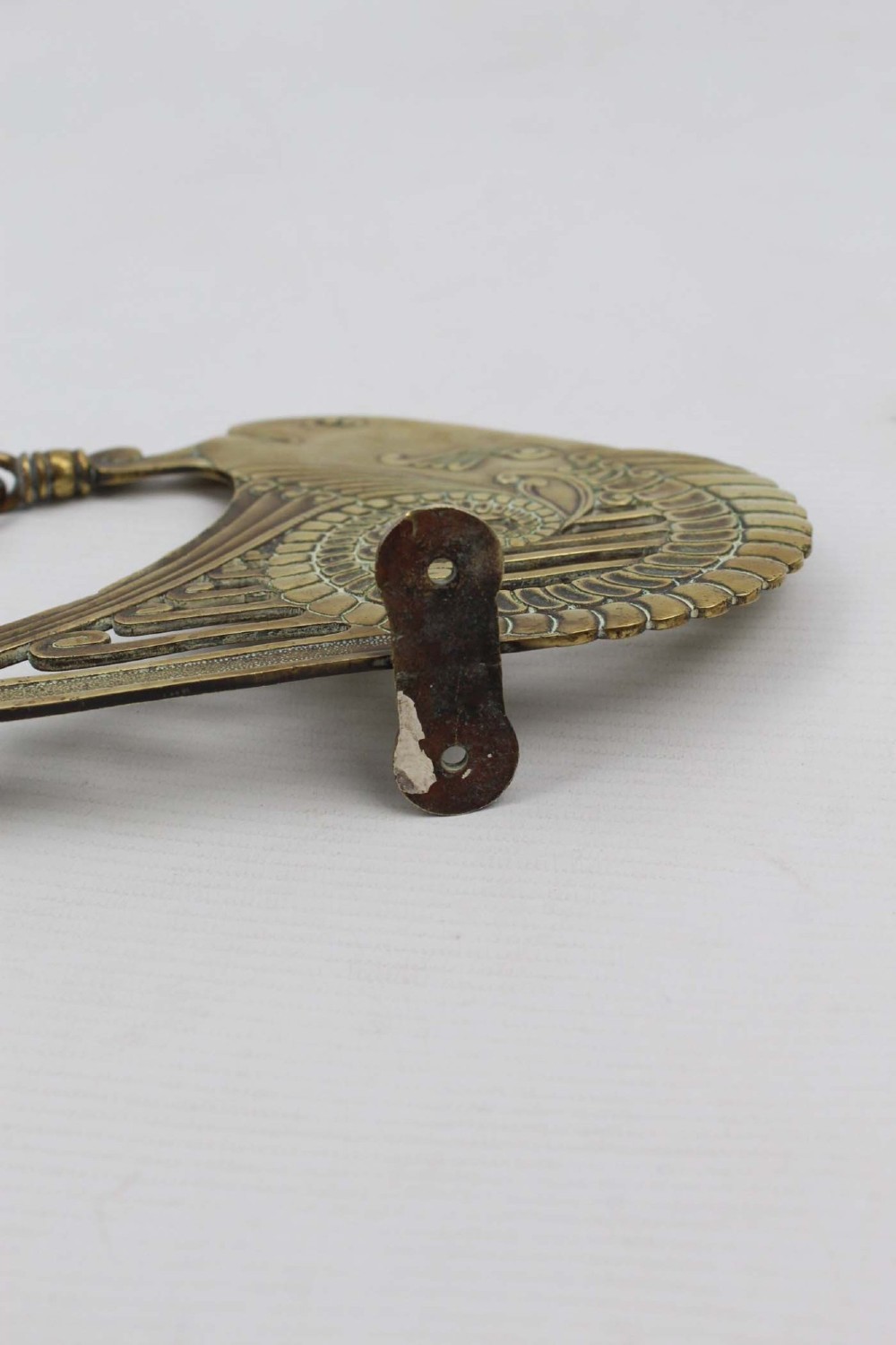 A stylized cast brass Art Deco wall hanging bracket featuring openwork scroll details and a lower swivel hook. View XI