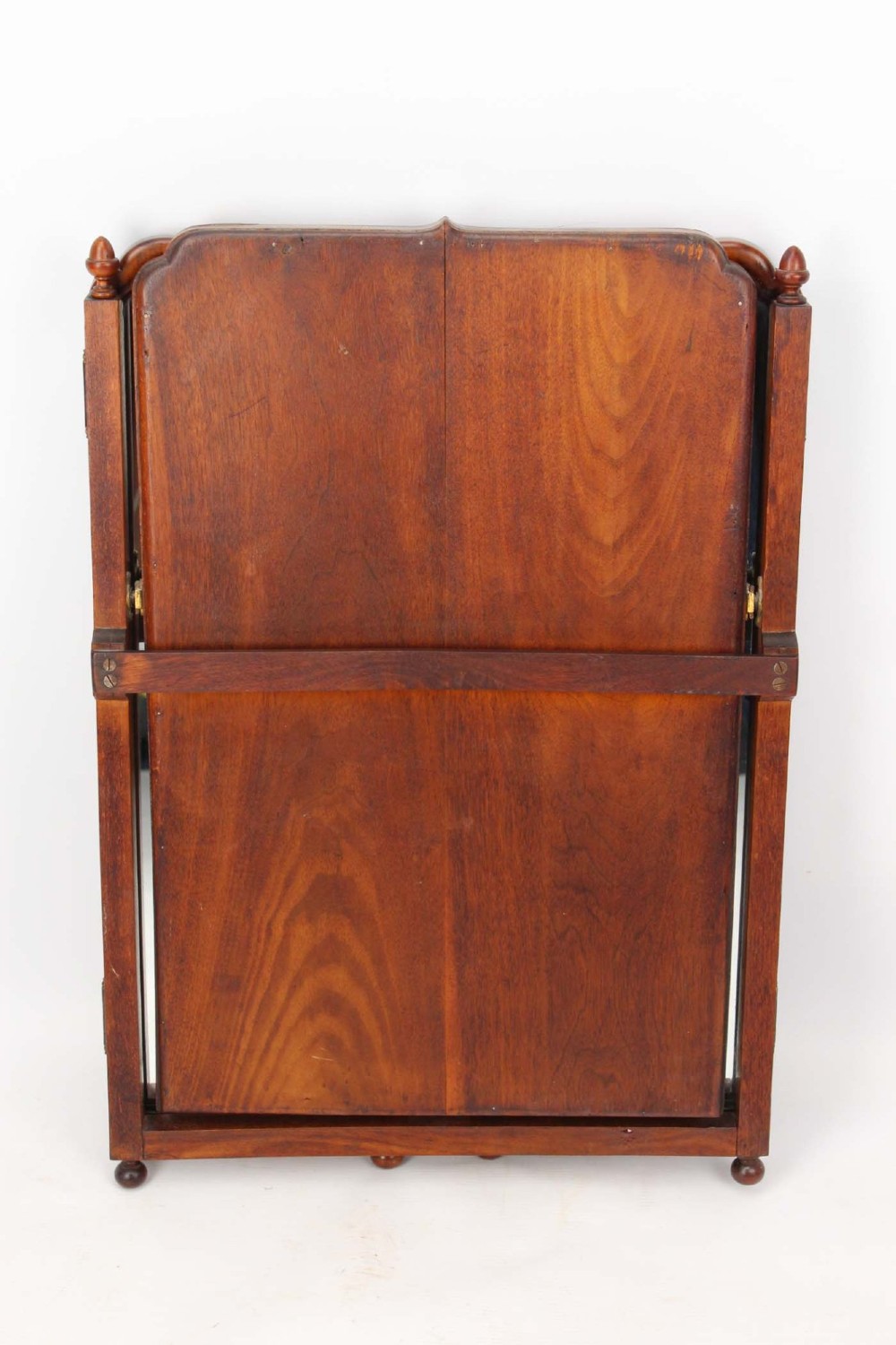 A three-panel walnut triptych dressing table mirror featuring arched side wings, turned finials, and brass hinges. View IV