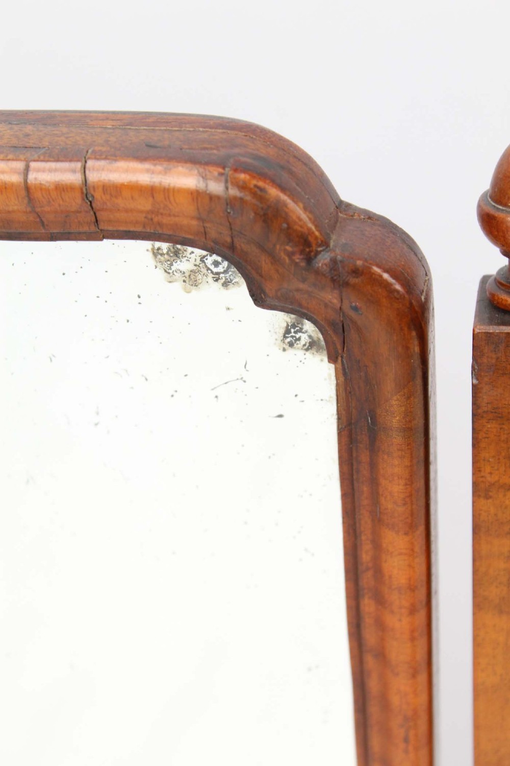 A three-panel walnut triptych dressing table mirror featuring arched side wings, turned finials, and brass hinges. View VII