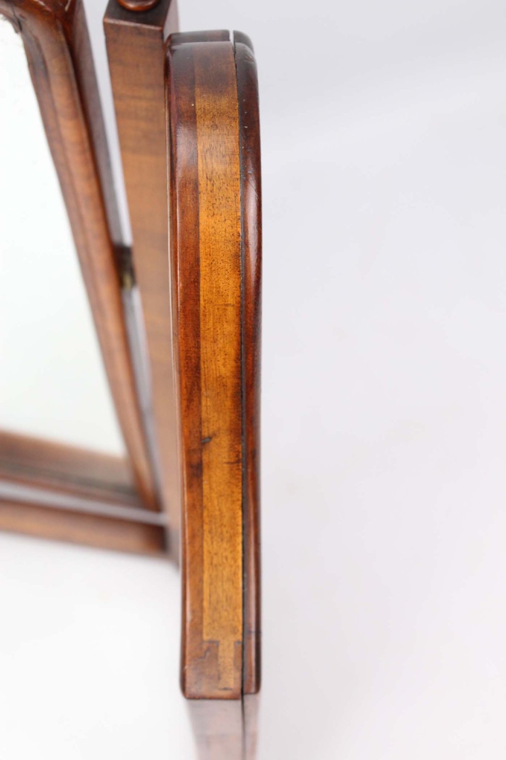 A three-panel walnut triptych dressing table mirror featuring arched side wings, turned finials, and brass hinges. View IX